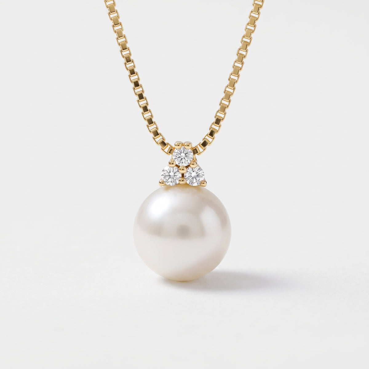 10mm white freshwater pearl pendant with three cubic zirconia accents on 14K yellow gold box chain