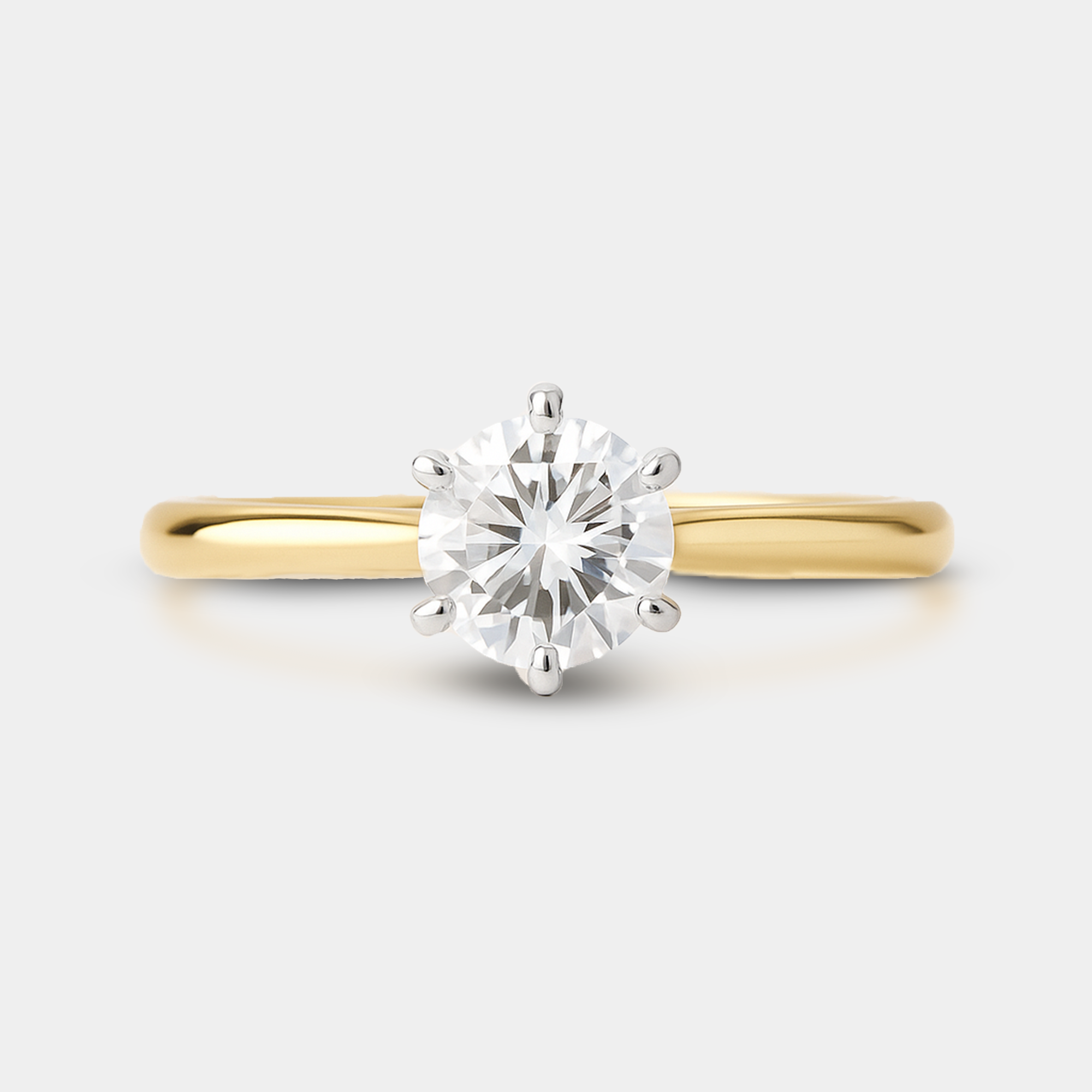 Top view of 14K gold solitaire moissanite engagement ring showing round brilliant cut sparkle and facet detail
