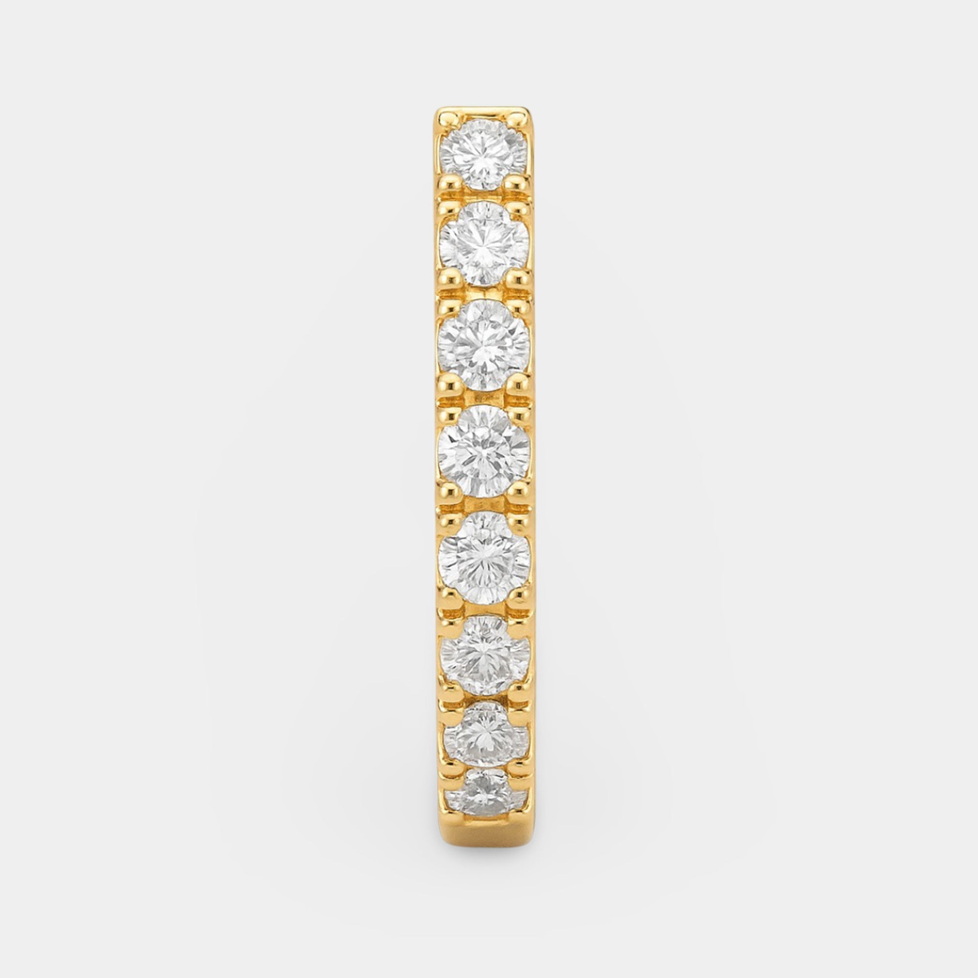 Side view of the gold-finished huggie hoop showing the clip-on closure