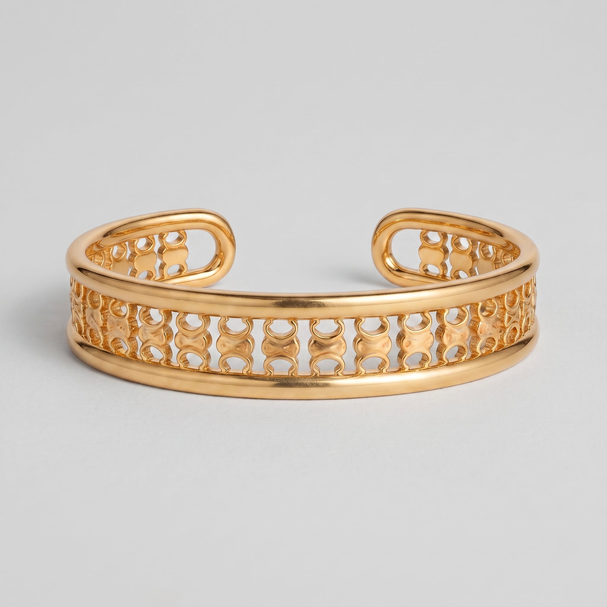 Gold openwork cuff bracelet in 18K gold plated copper with a cut-out band