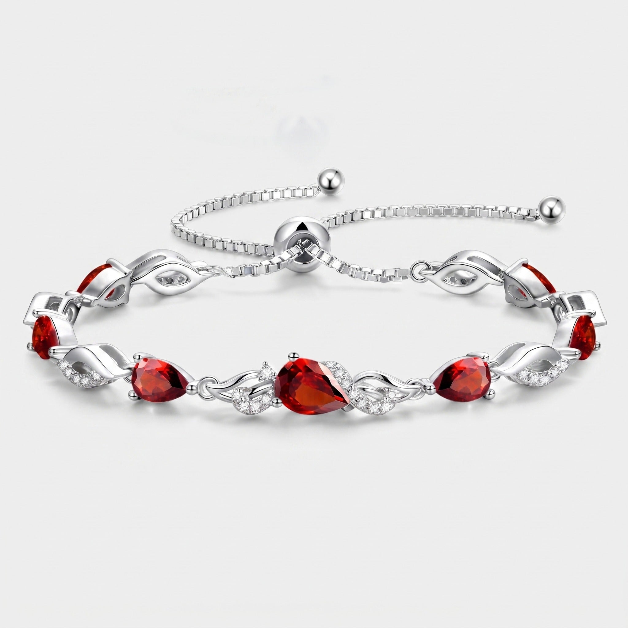 Sterling silver garnet teardrop tennis bracelet with adjustable bolo chain on white background