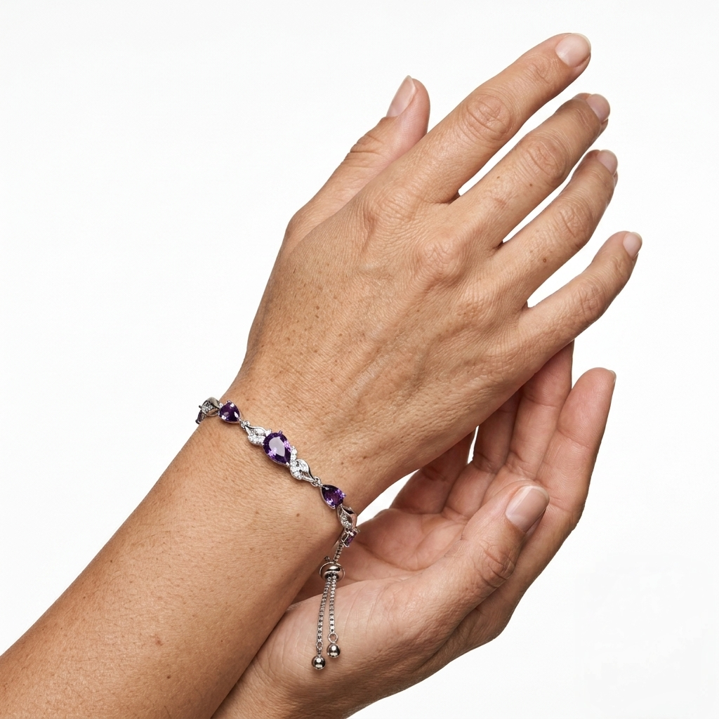 Close-up of hands showing amethyst tennis bracelet on wrist