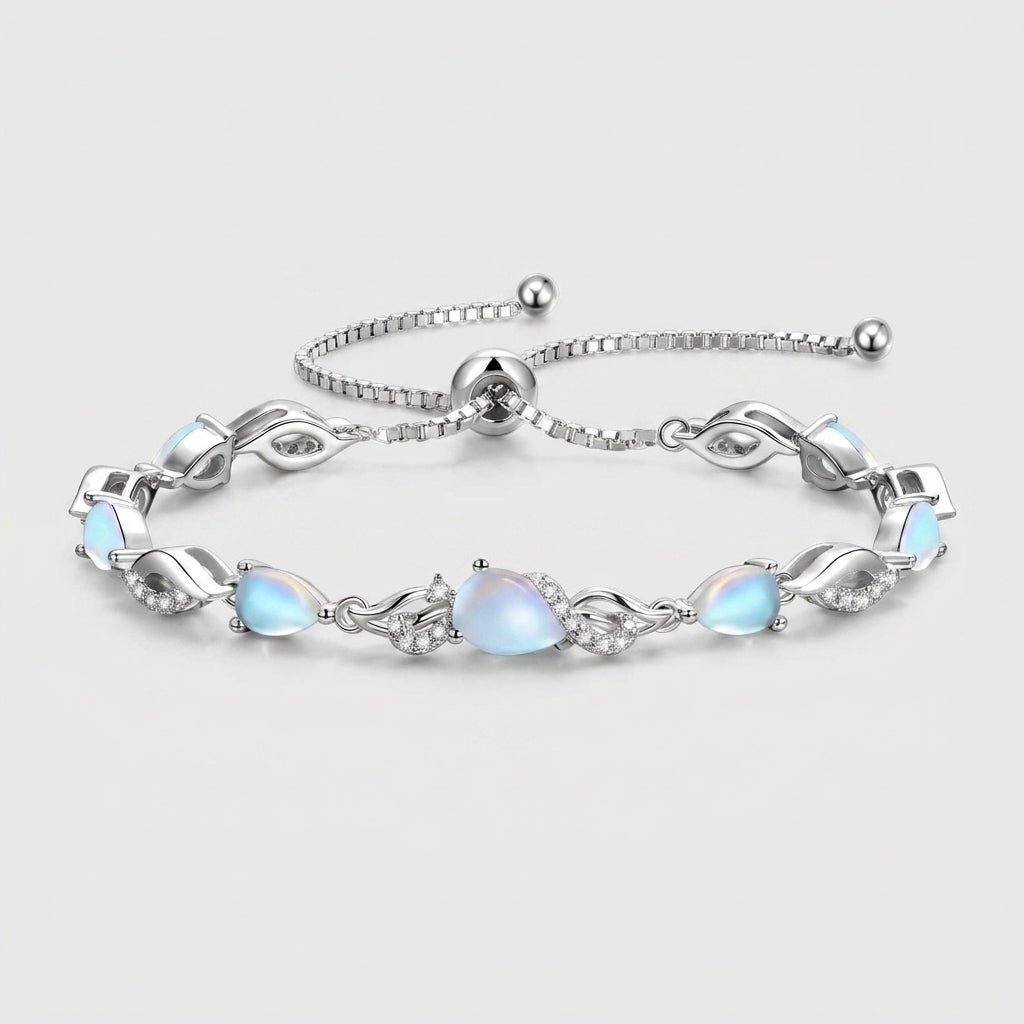 Moonstone teardrop tennis bracelet in sterling silver laid flat, showing the adjustable bolo clasp and leaf-link design.