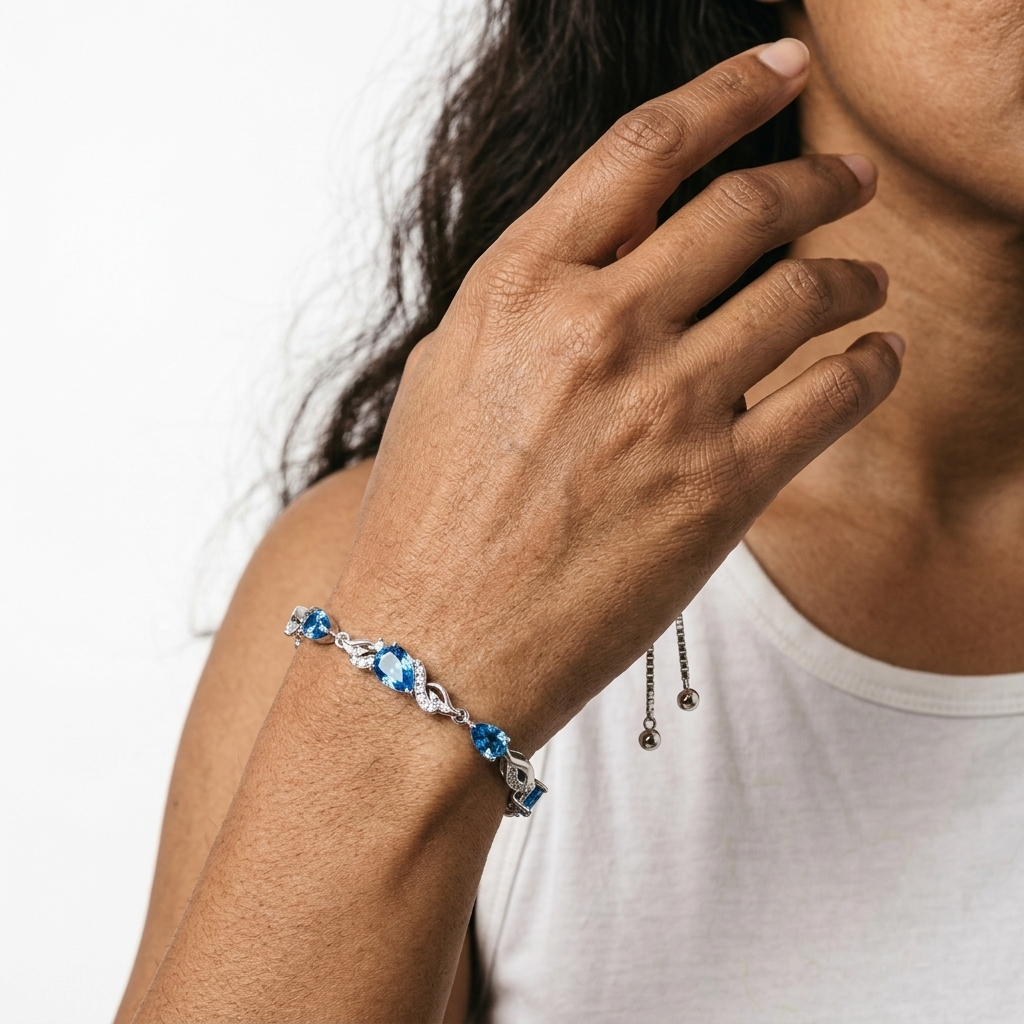 Woman wearing the blue topaz bracelet on her wrist, showing the full length of the bolo chain.