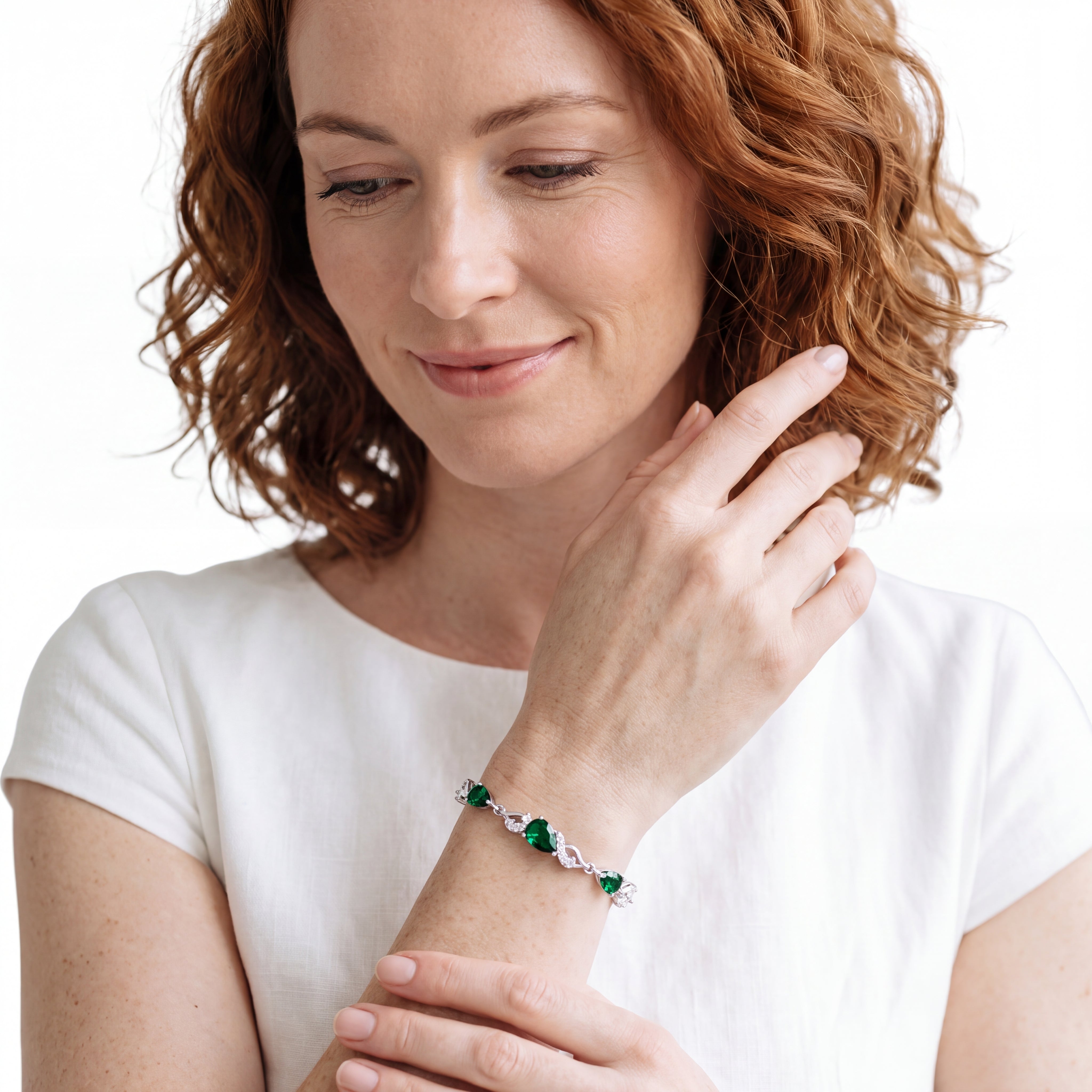 Close-up of emerald teardrop bracelet worn on the wrist
