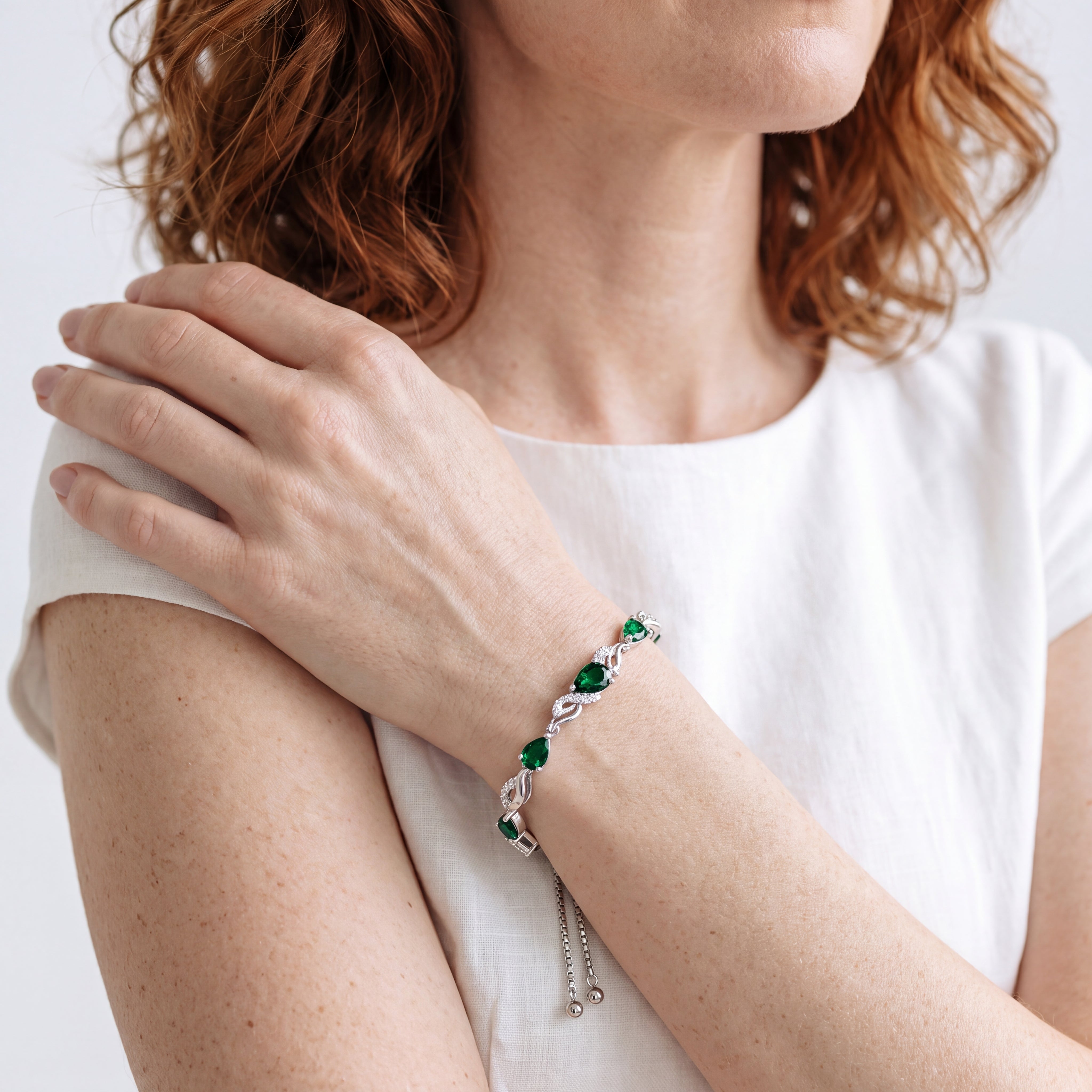 Front, side, back, and macro views of the emerald teardrop tennis bracelet