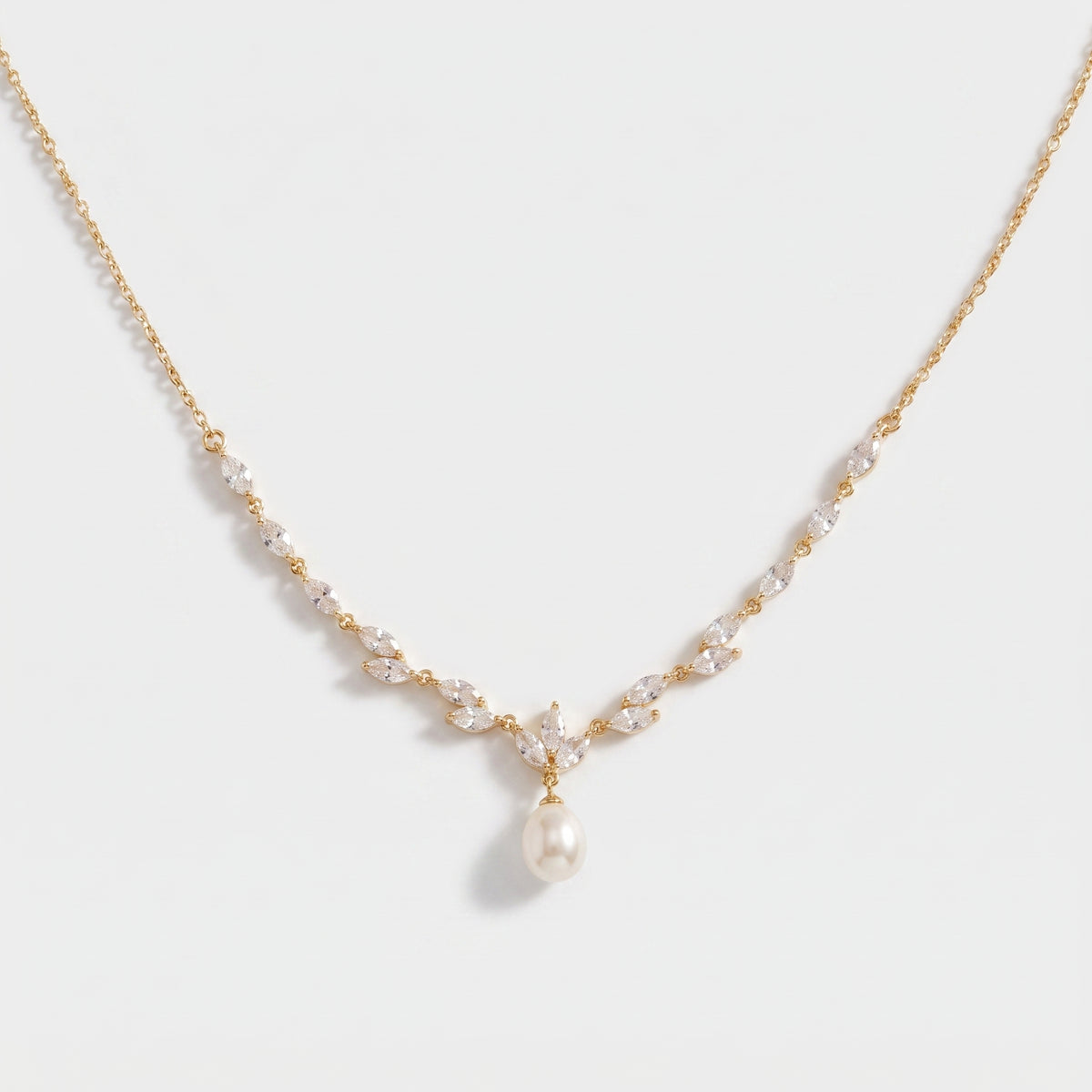 Gold bridal necklace with marquise CZ vine stones and a teardrop pearl drop in the center