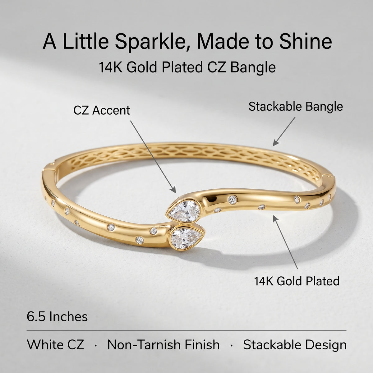A gold-plated CZ bangle bracelet with labeled callouts and text on a light gray background. The image includes the text 'A Little Sparkle, Made to Shine', '14K Gold Plated CZ Bangle', and feature notes such as 'CZ Accent', 'Stackable Bangle', '6.