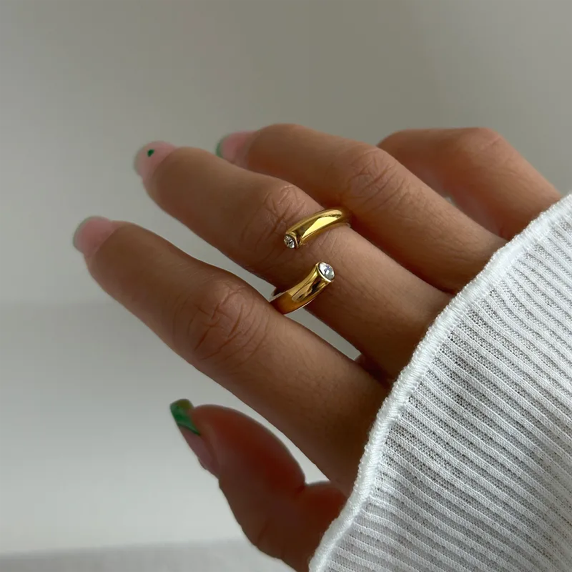 Side profile of adjustable dainty 14K gold ring showing band height and minimalist polished finish