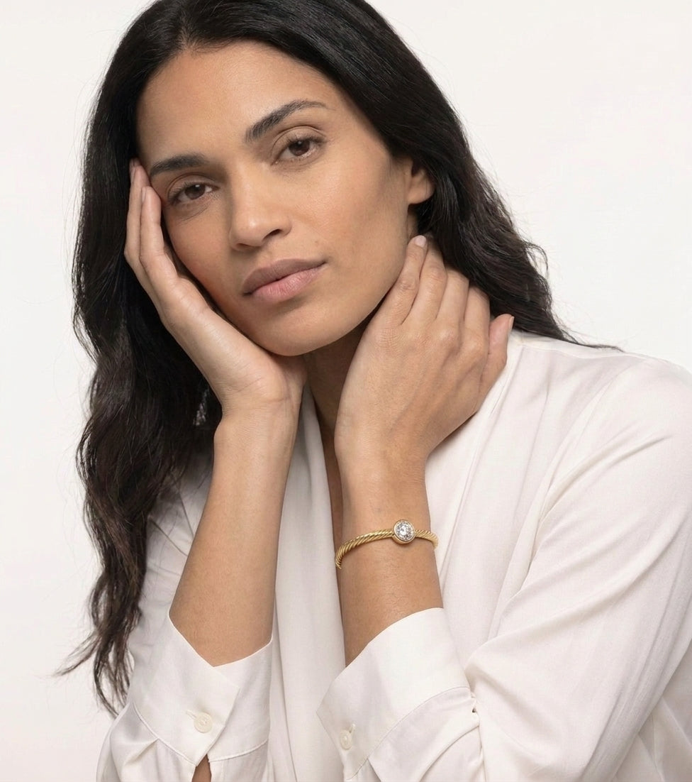 Close view of the 18K gold plated twisted rope bracelet with cubic zirconia worn on a woman's wrist