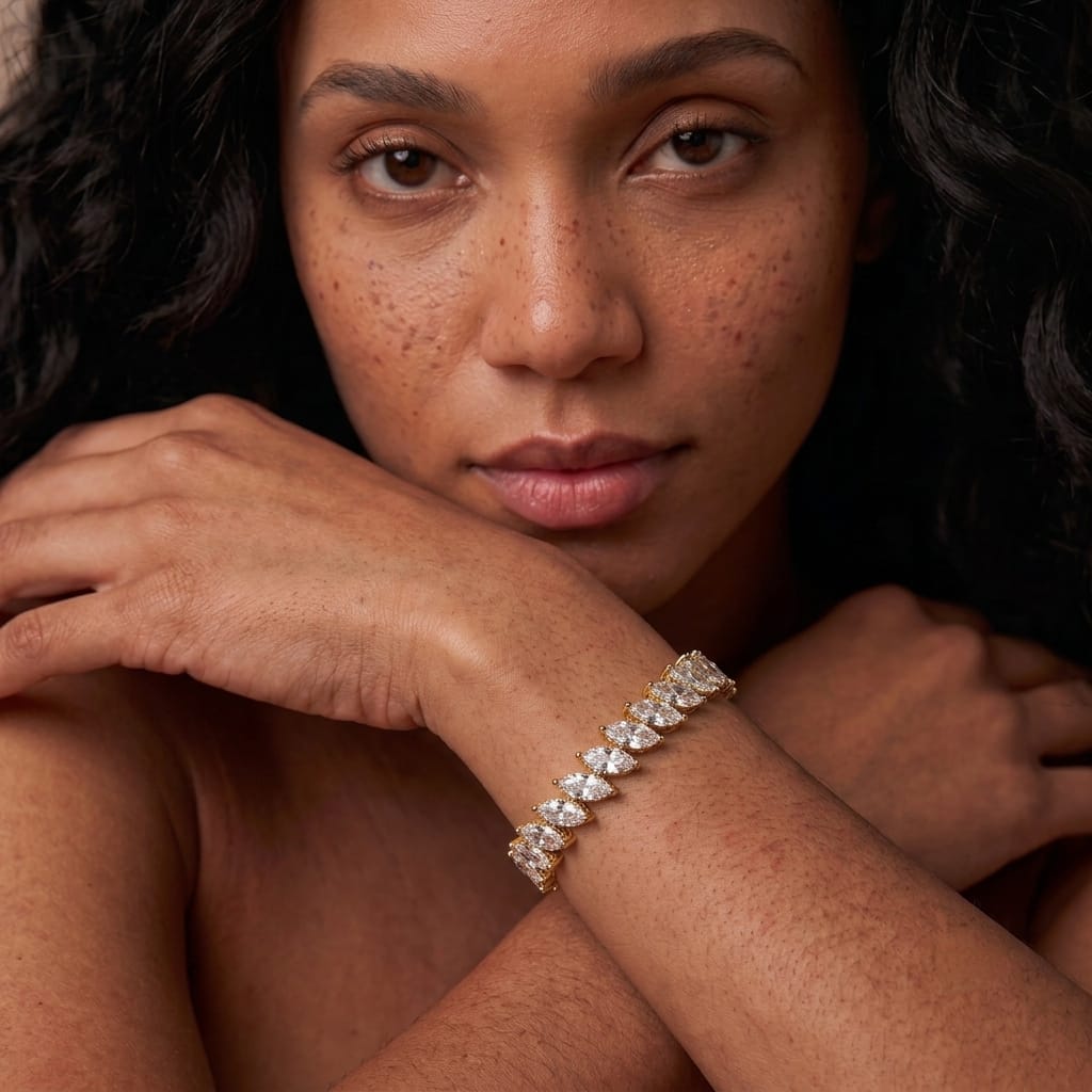 Woman wearing the MH Elegance bold marquise tennis bracelet with a single row of large gold set stones