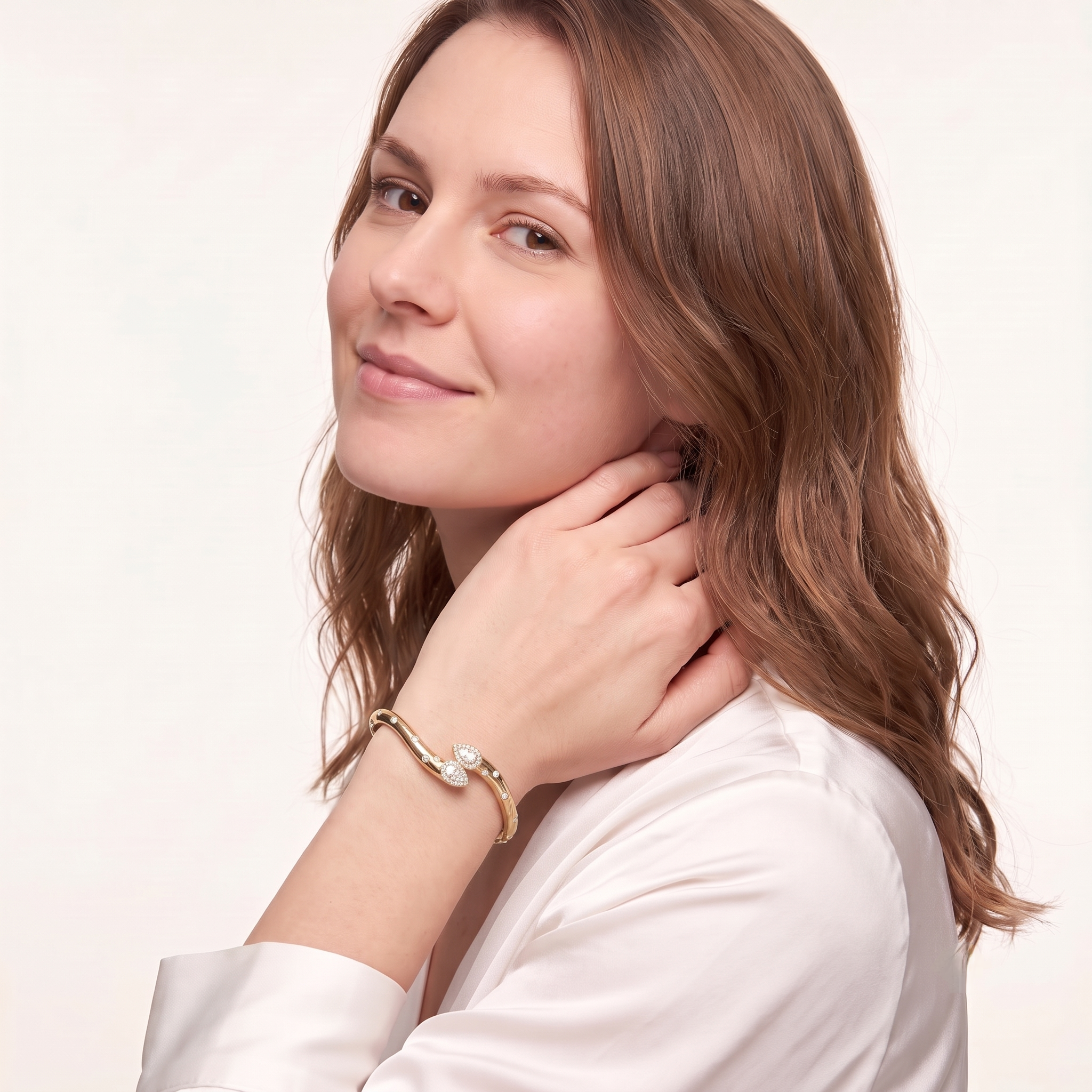 Woman smiling while wearing the gold plated double pear cubic zirconia bangle bracelet for women