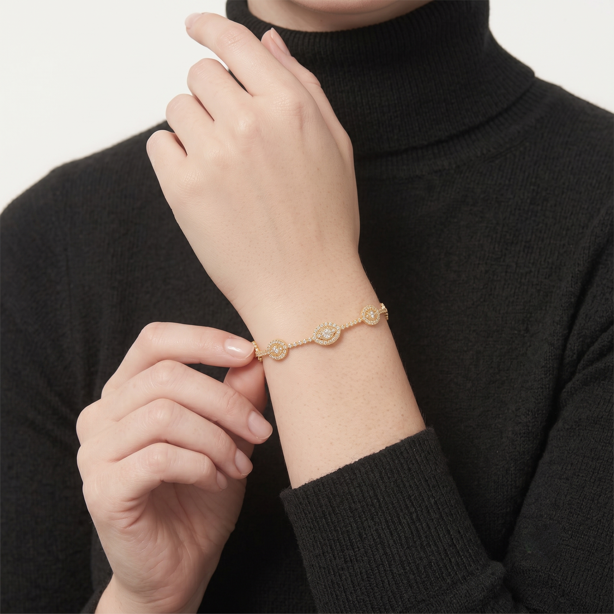 Close-up portrait of a woman wearing the 14K gold filled pave cubic zirconia evil eye bangle bracelet