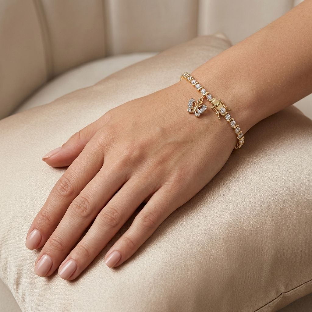 Woman wearing an 18K gold plated butterfly tennis bracelet with a safety clasp