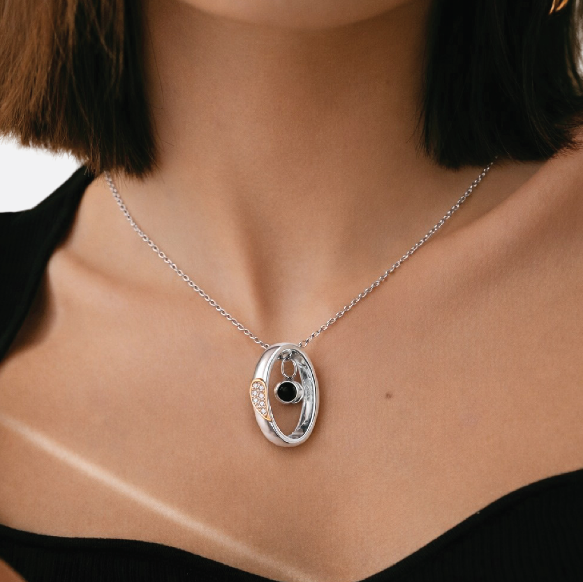 Close-up of sterling silver projection photo stone pendant showing custom photo under light