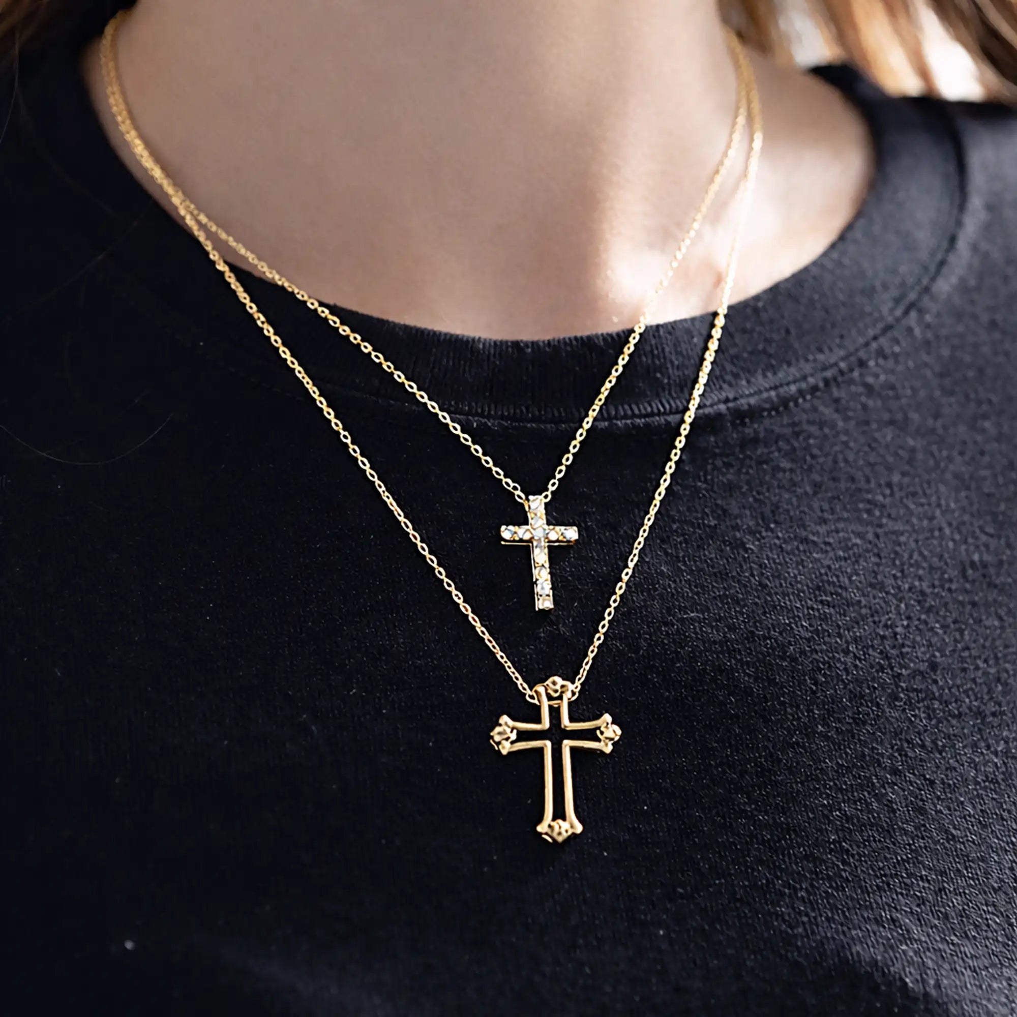 Close-up of CZ stone accents on gold puzzle cross couple pendant necklace set