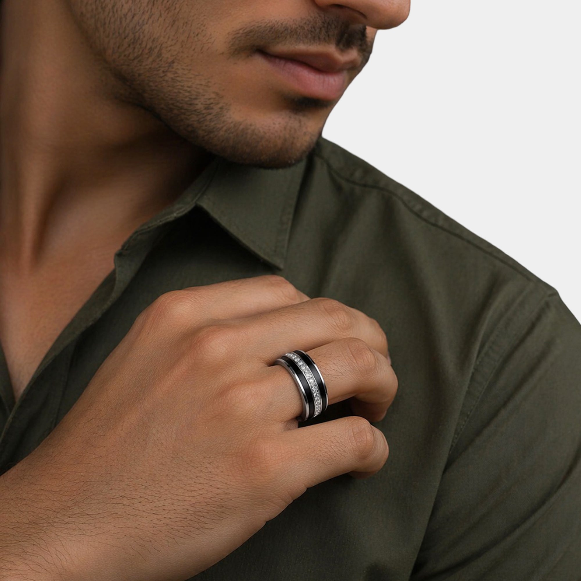 Close-up of the round moissanite on a black finish men's band