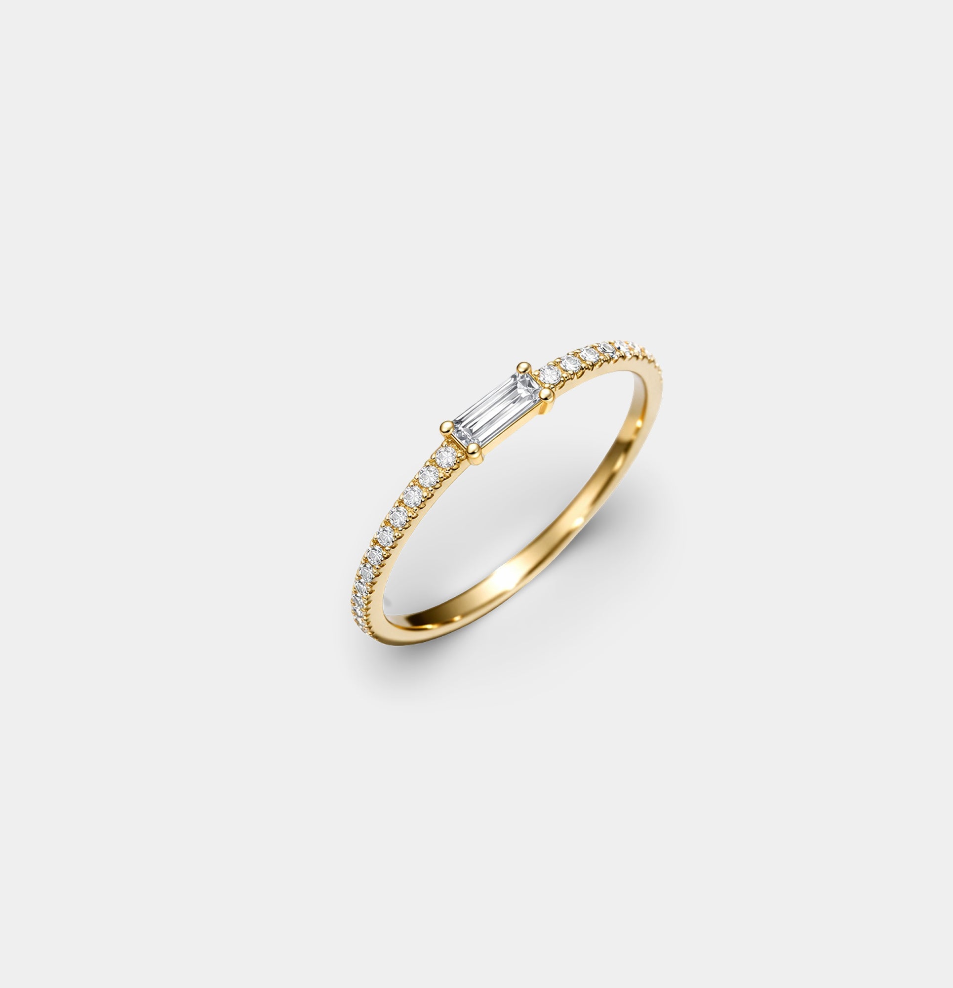 MH Elegance Celeste Spark gold baguette eternity ring on a neutral background