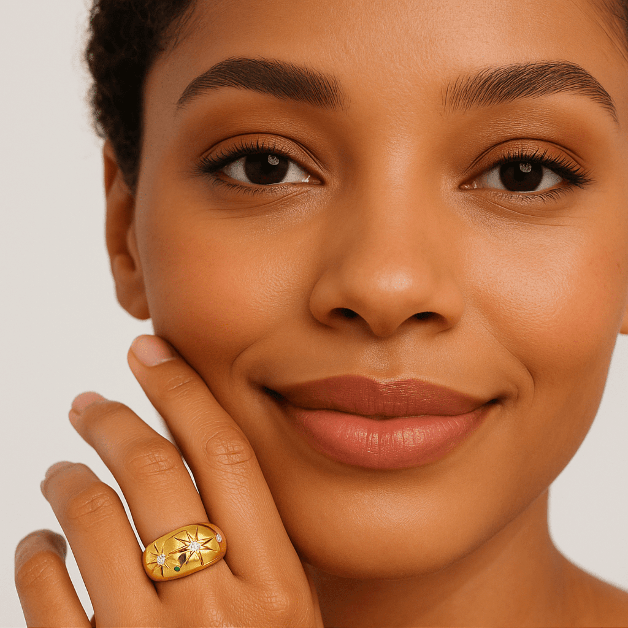 Woman wearing the gold celestial starburst ring on her hand, showing everyday statement styling