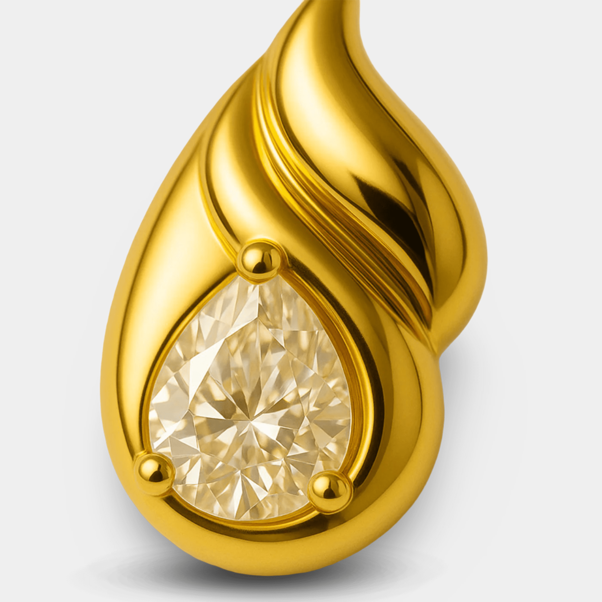 Gold-plated double teardrop stud earrings displayed on a soft background.