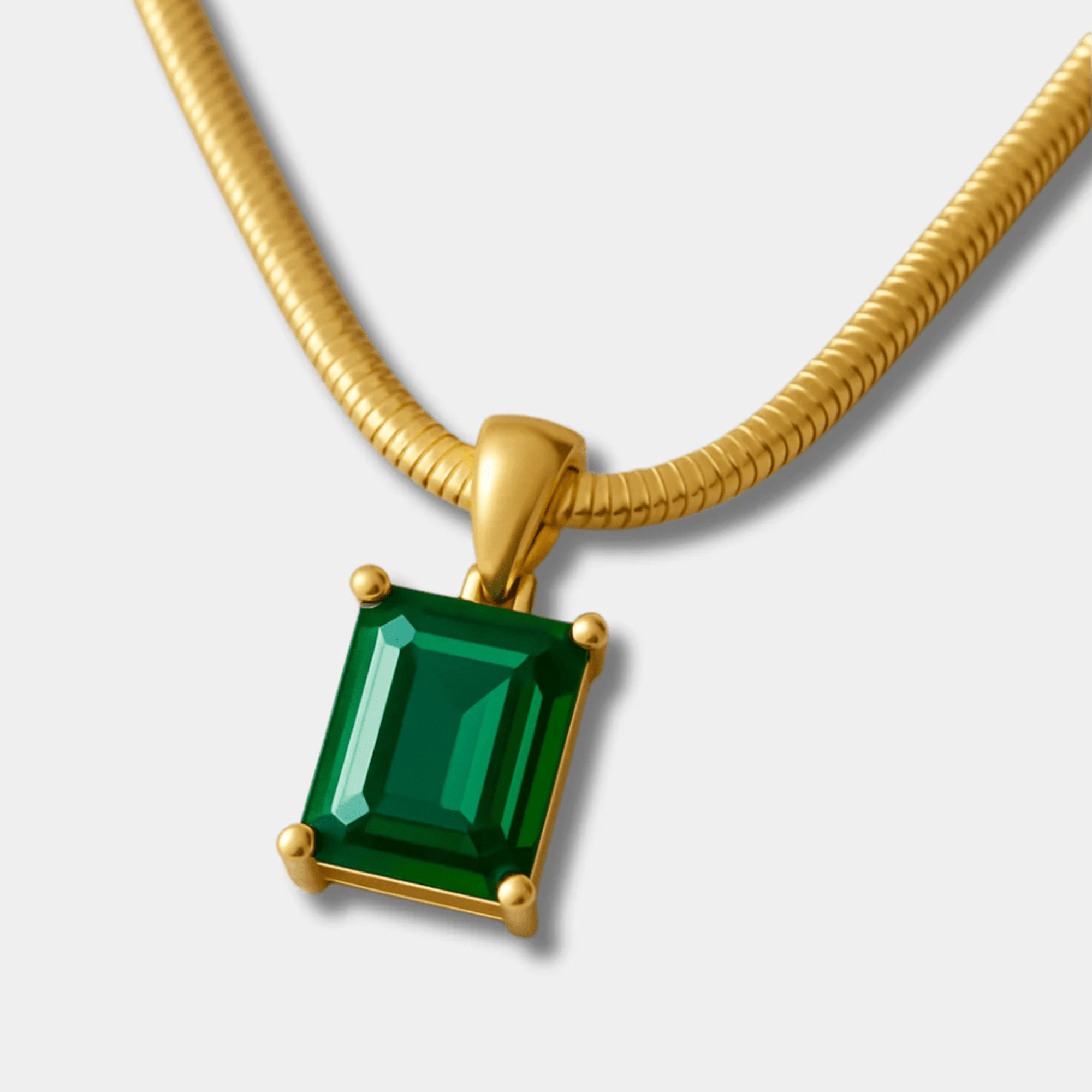 Emerald-green zircon pendant necklace shown flat with its gold chain.