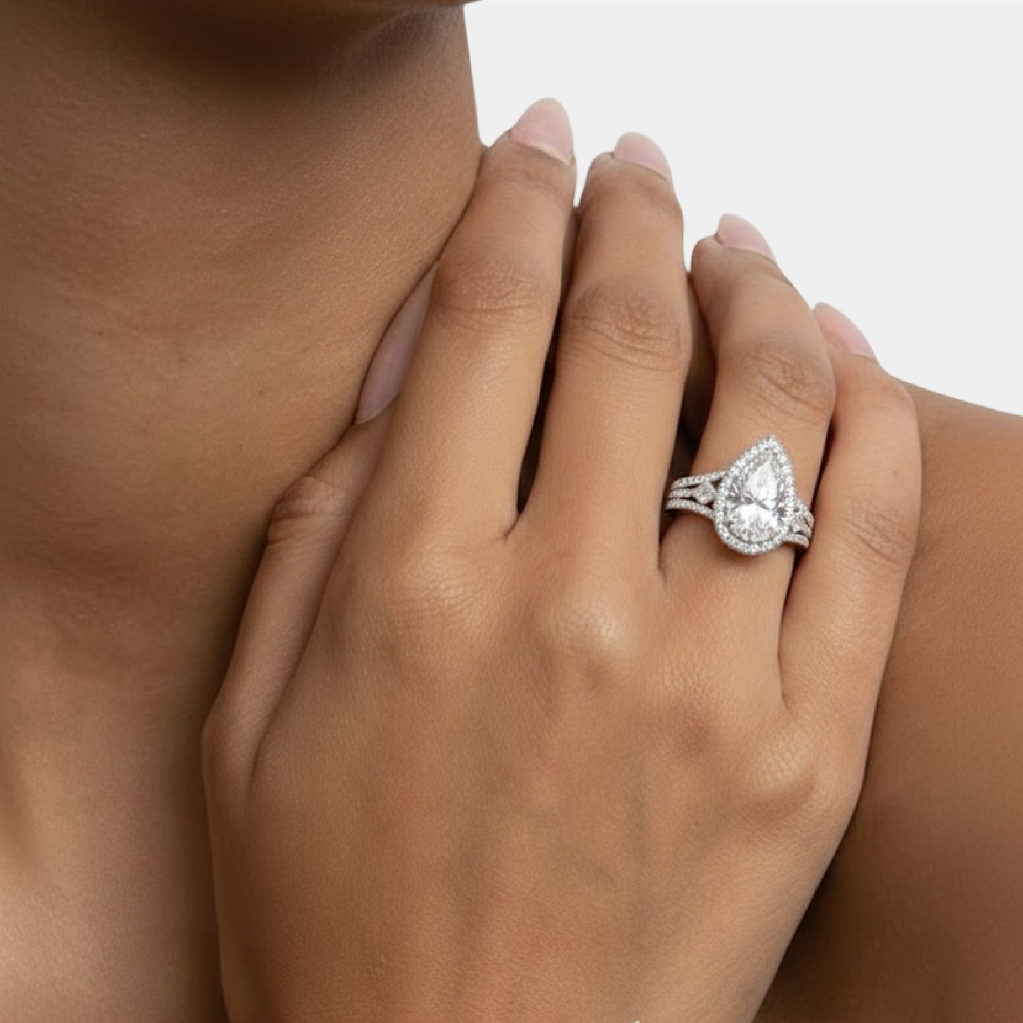 Couple wearing the matching pear CZ his and hers wedding rings, lifestyle photo