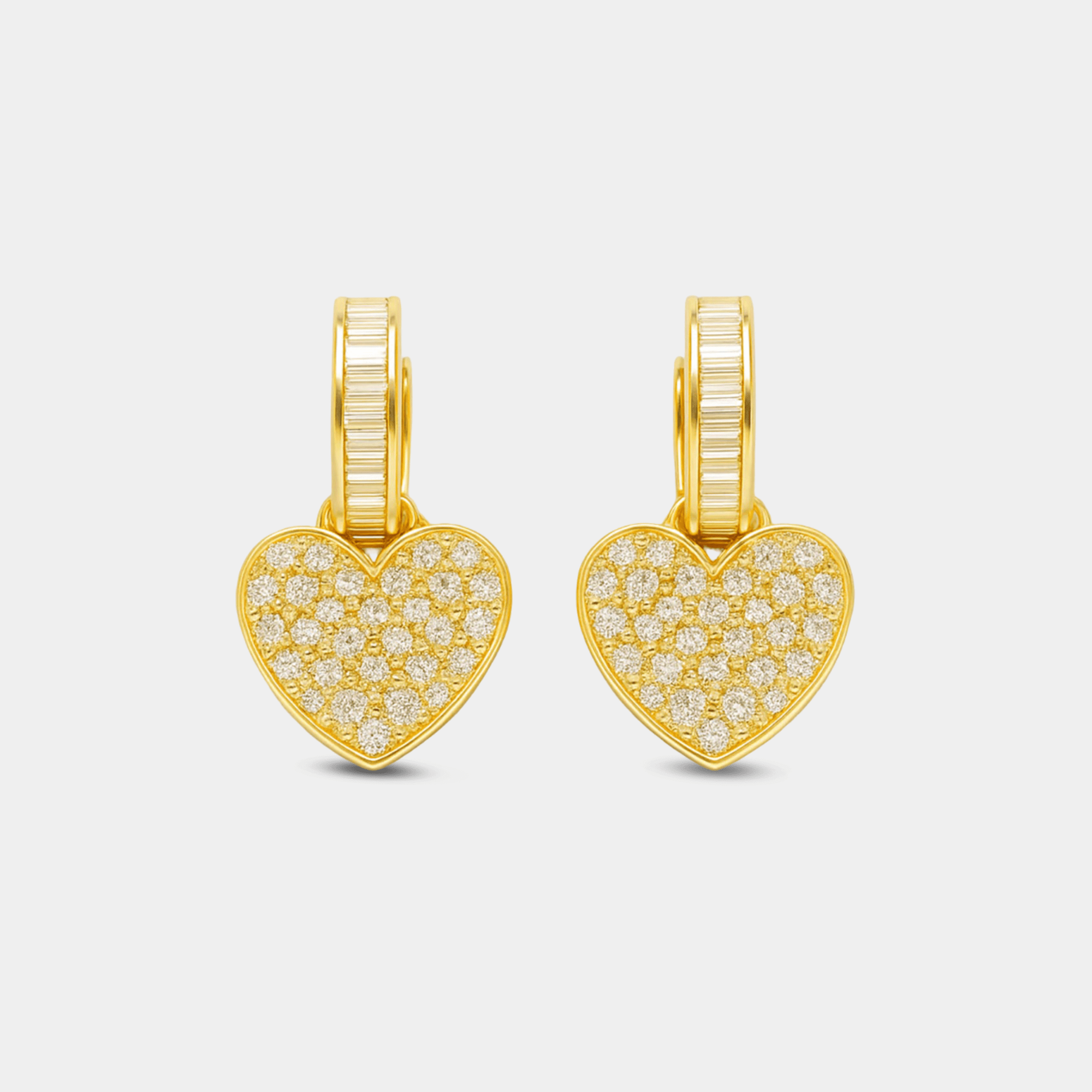 Gold heart stud earrings displayed on a soft background.