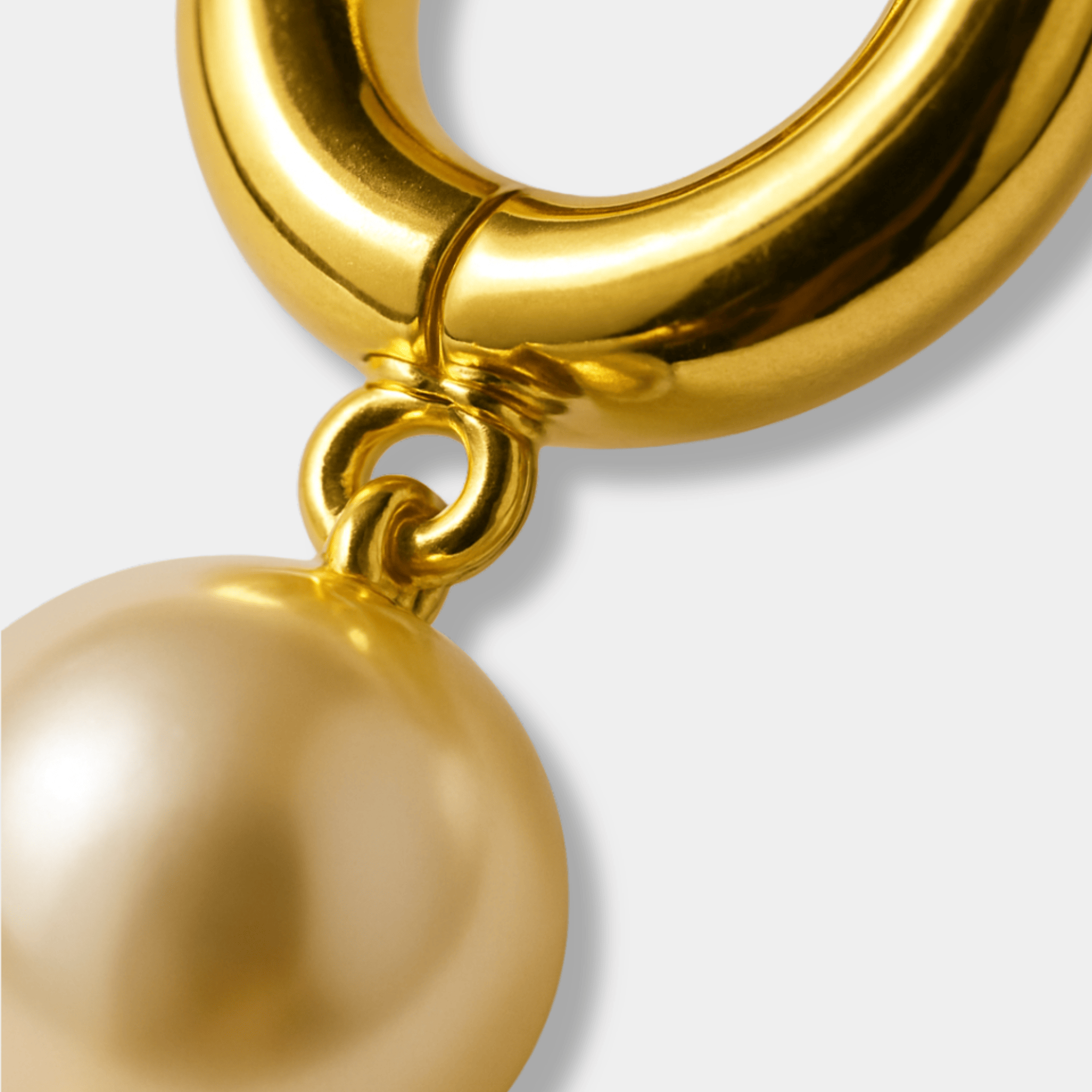 Close-up of Goldie Pearl hoop earring showing genuine freshwater pearl and waterproof gold plated finish