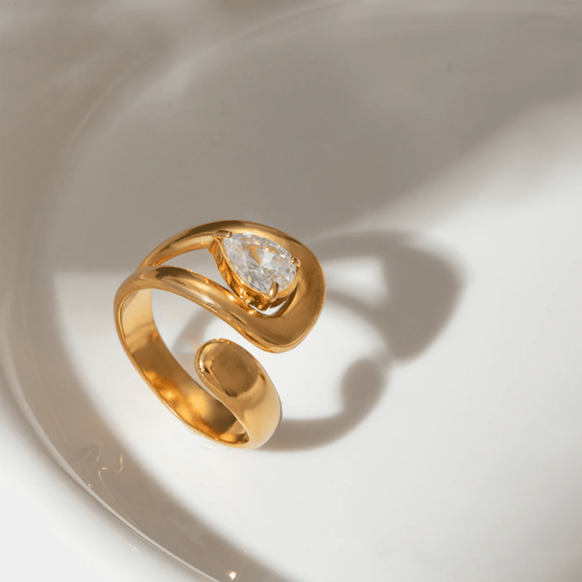 Top view of the HaloFold twist ring showing the geometric halo design in gold-plated stainless steel