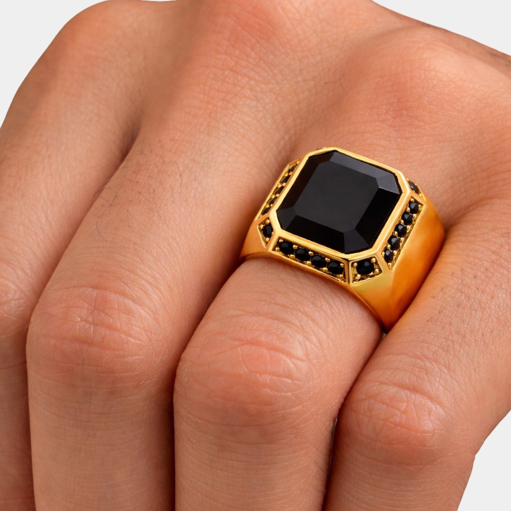 Close-up of the octagonal black onyx stone on a gold men's signet ring