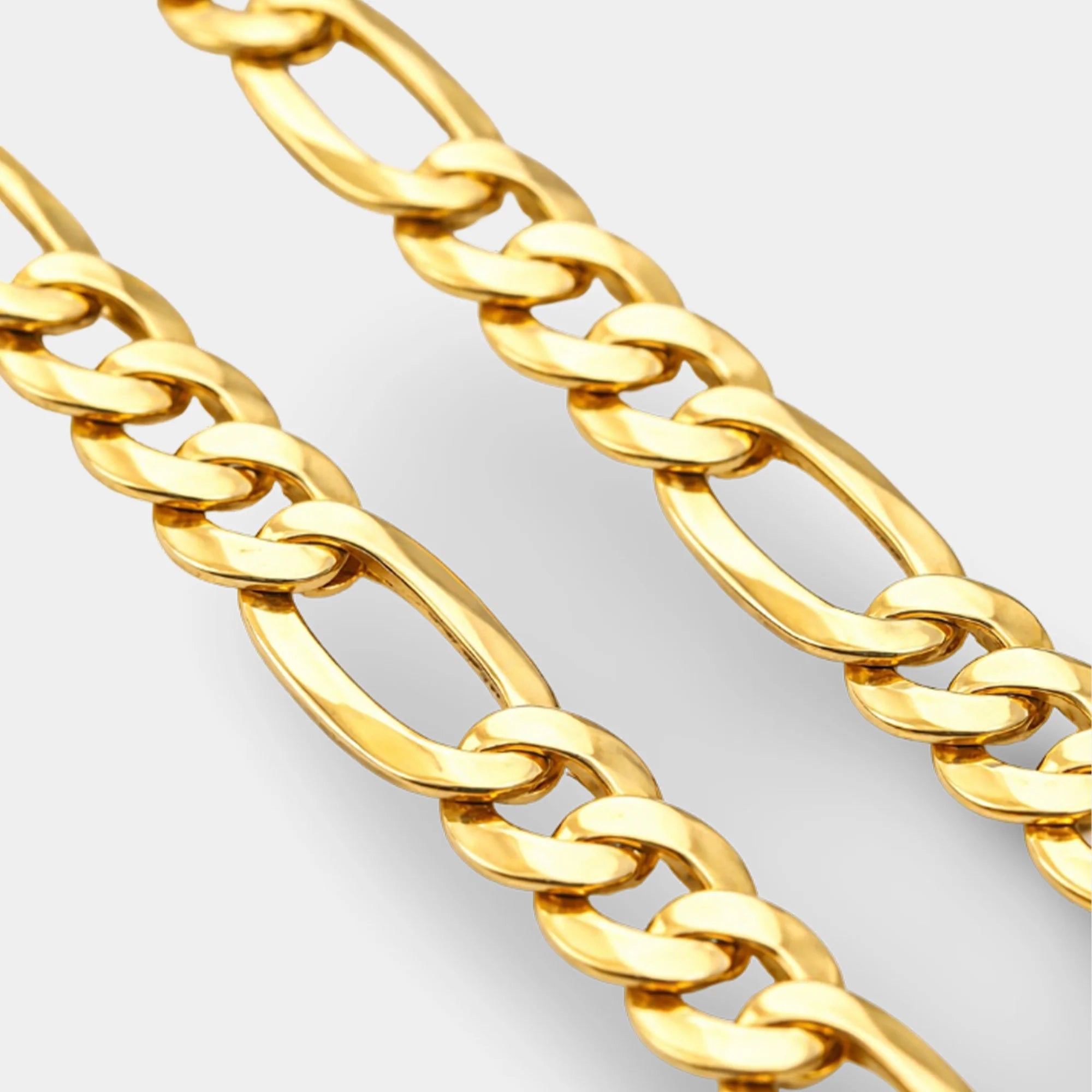 Gold Figaro chain necklace shown on the neck