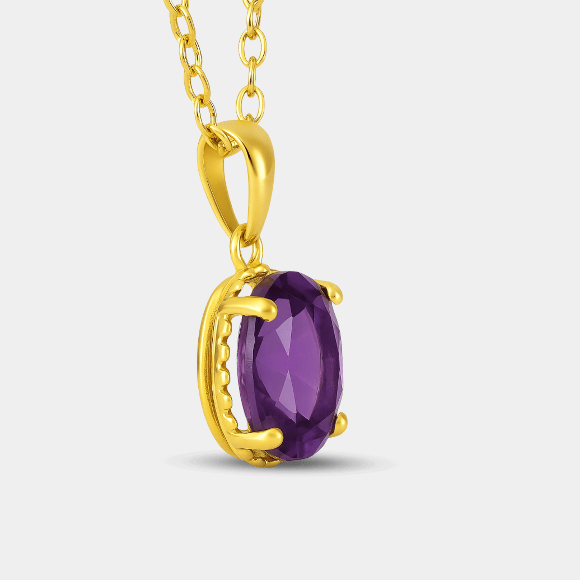 Close-up side view of the amethyst pendant showing the gold prongs and beaded frame around the purple stone