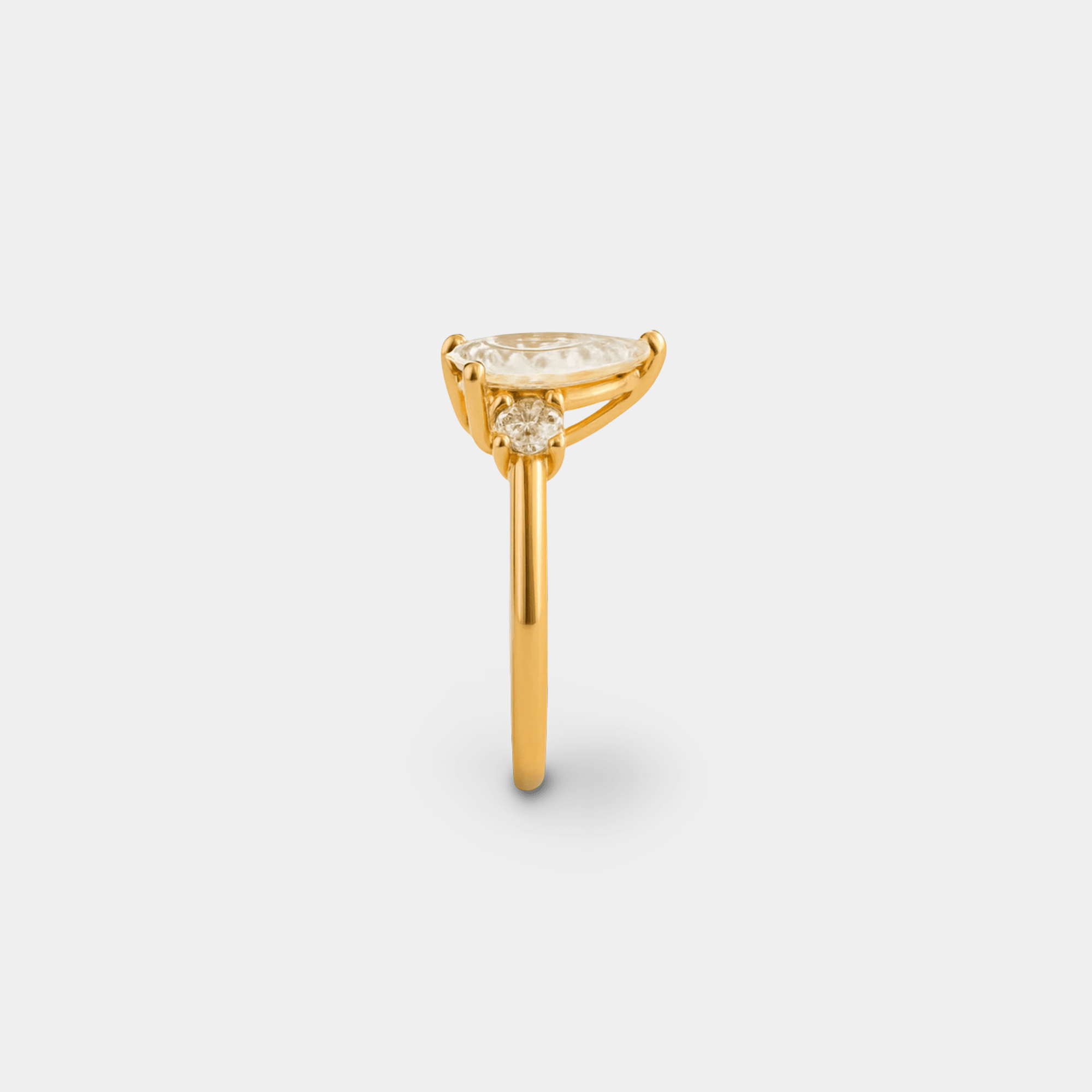 Side profile of the majestic pear zircon ring showing the gallery, prong setting, and adjustable gold band
