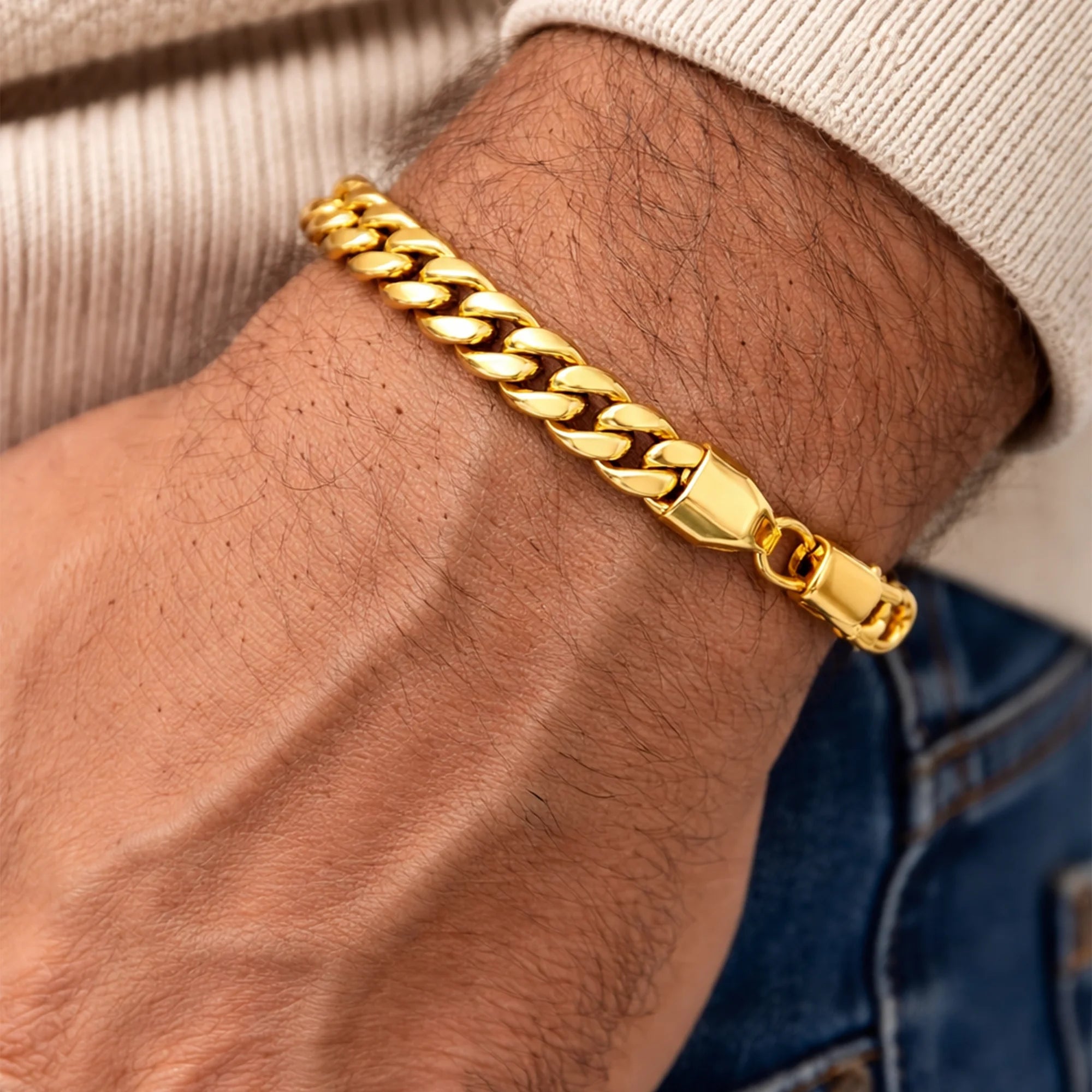 Detail of the strong lobster claw clasp on the 6mm gold Miami Cuban link bracelet
