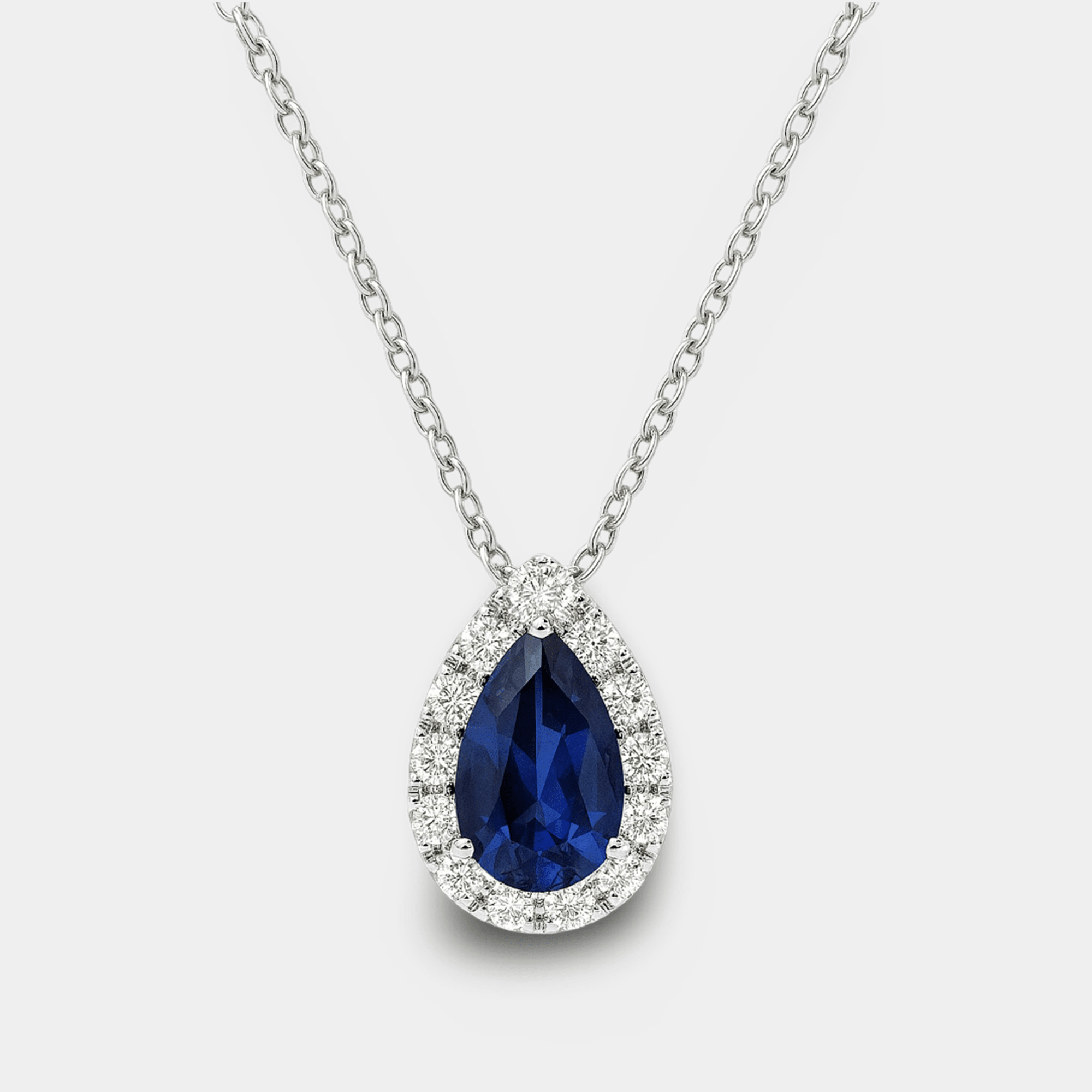 Pear cut blue sapphire and diamond halo pendant necklace in sterling silver