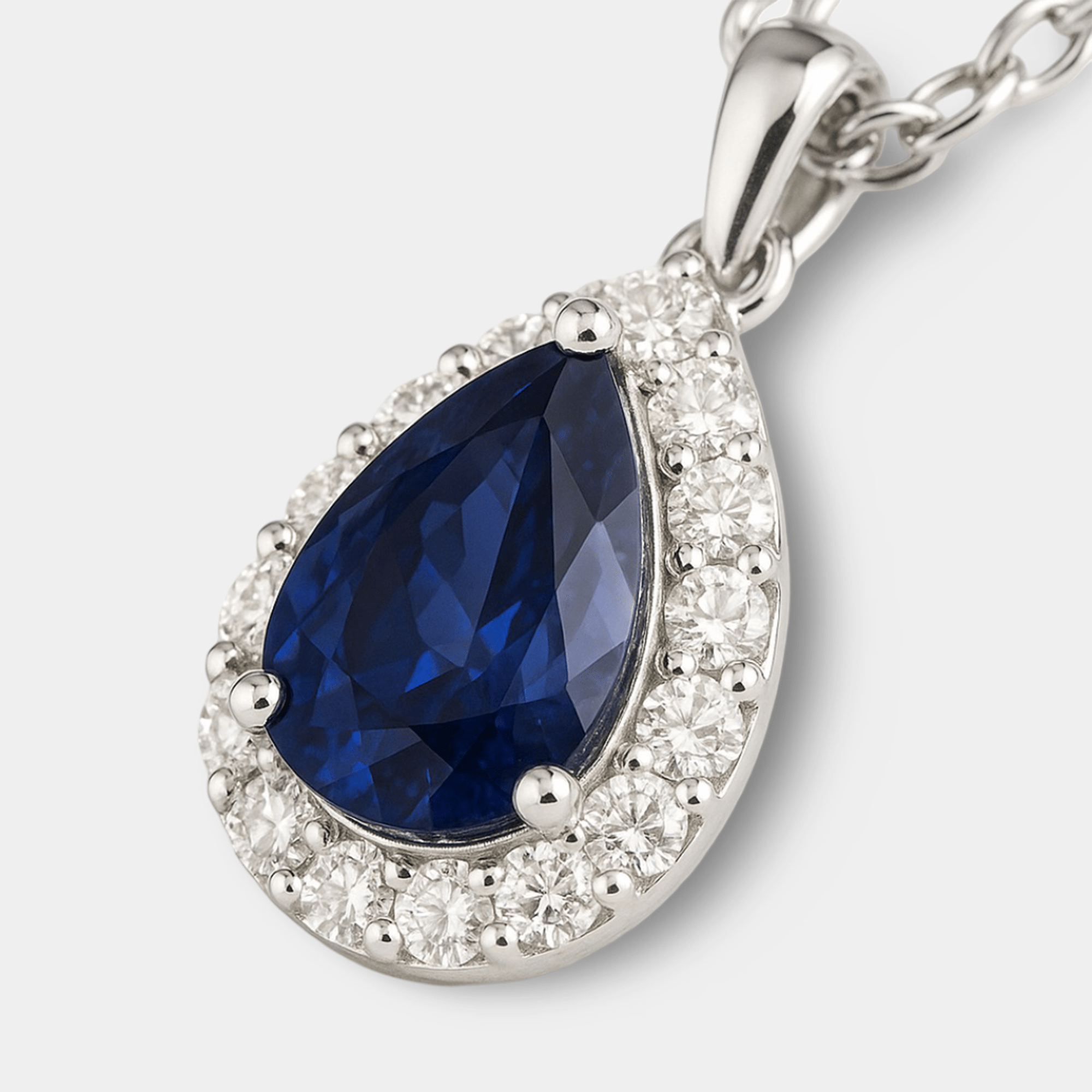Blue sapphire halo pendant shown on its adjustable white gold finish chain