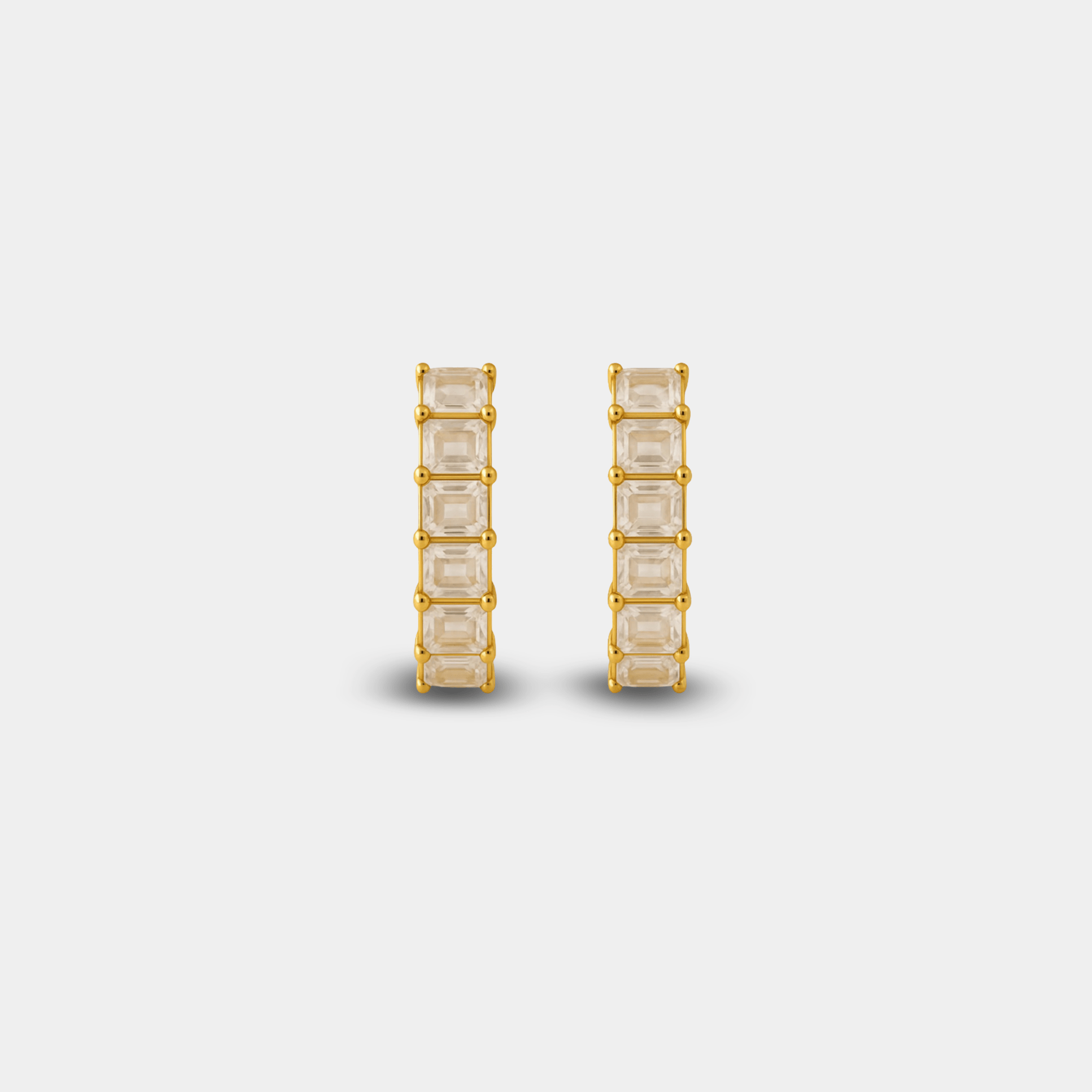 Close-up of the hand-set zircon inlay detail on the prism crown hoop earrings