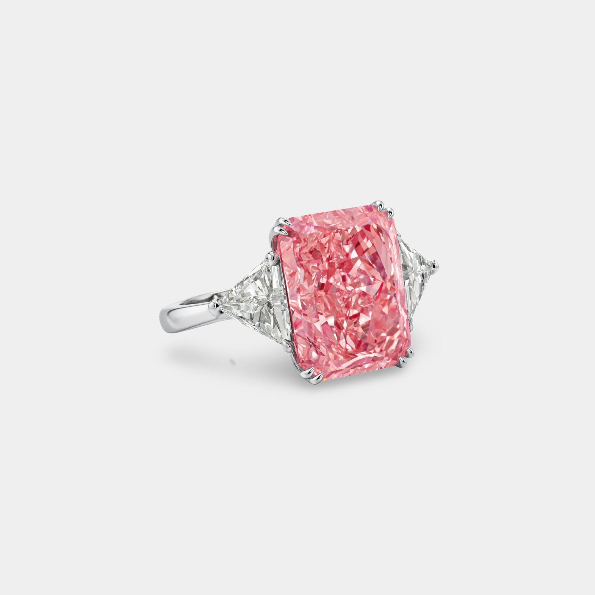 Pink radiant moissanite ring in white gold plated silver, top view of the stones