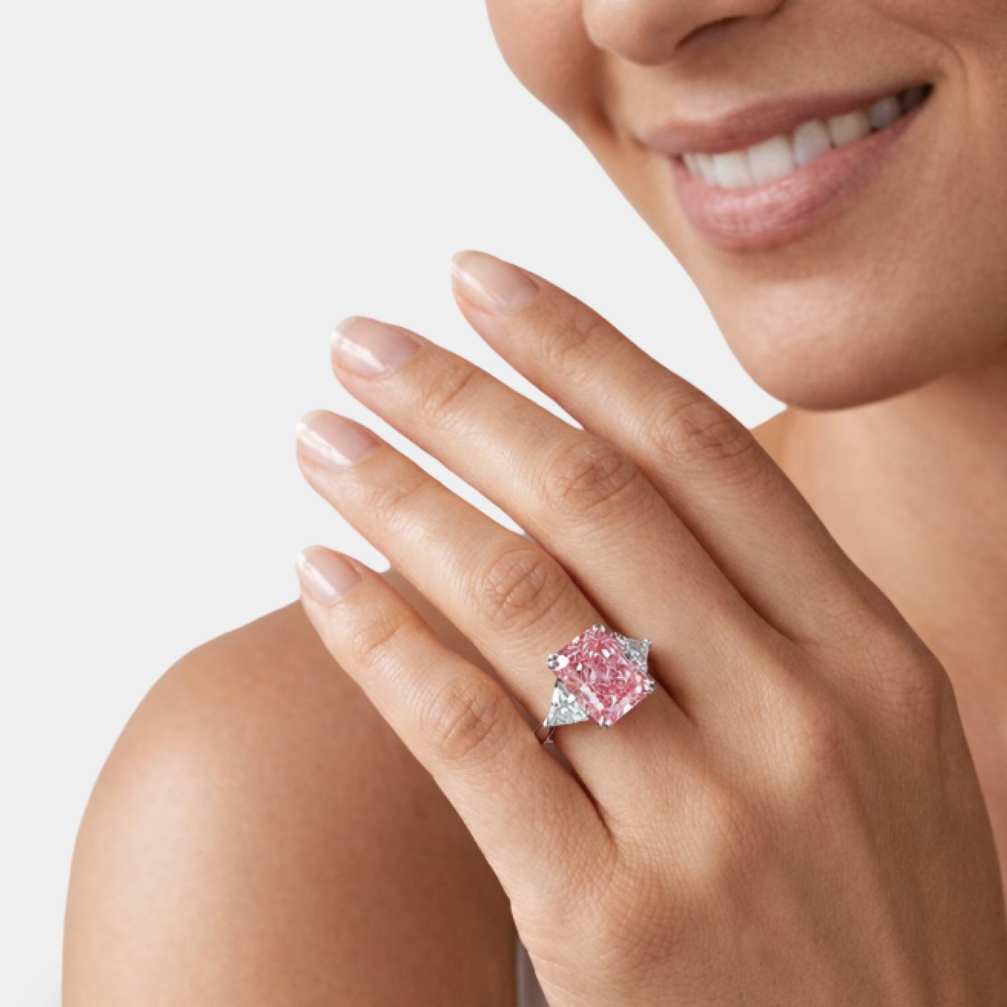 Close-up of the pink radiant cut moissanite center stone in a four prong setting