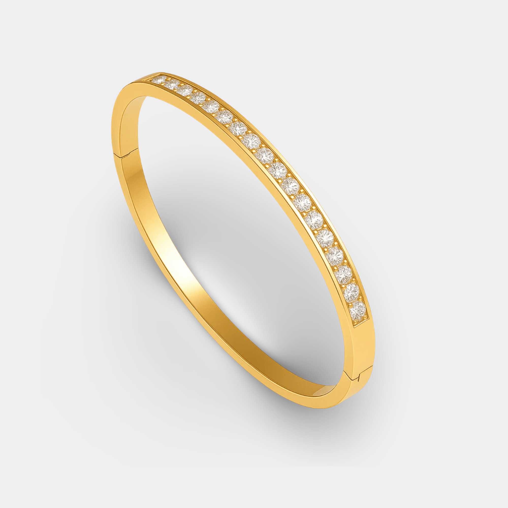 Close-up of the round rhinestone pendant on the gold bracelet