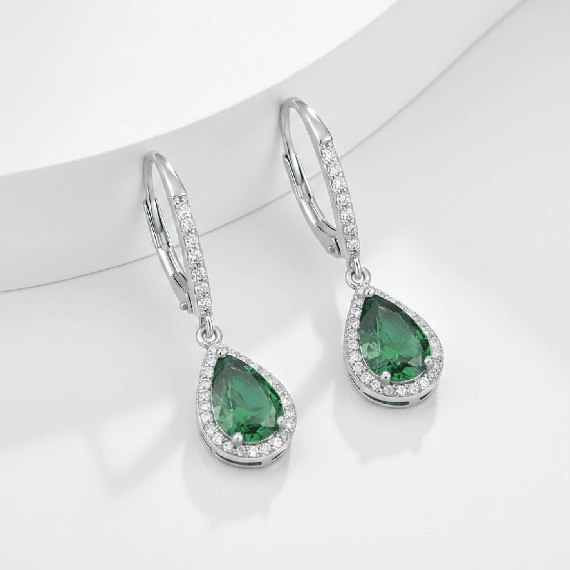 Pair of emerald birthstone drop earrings in their gift-ready MH Elegance box