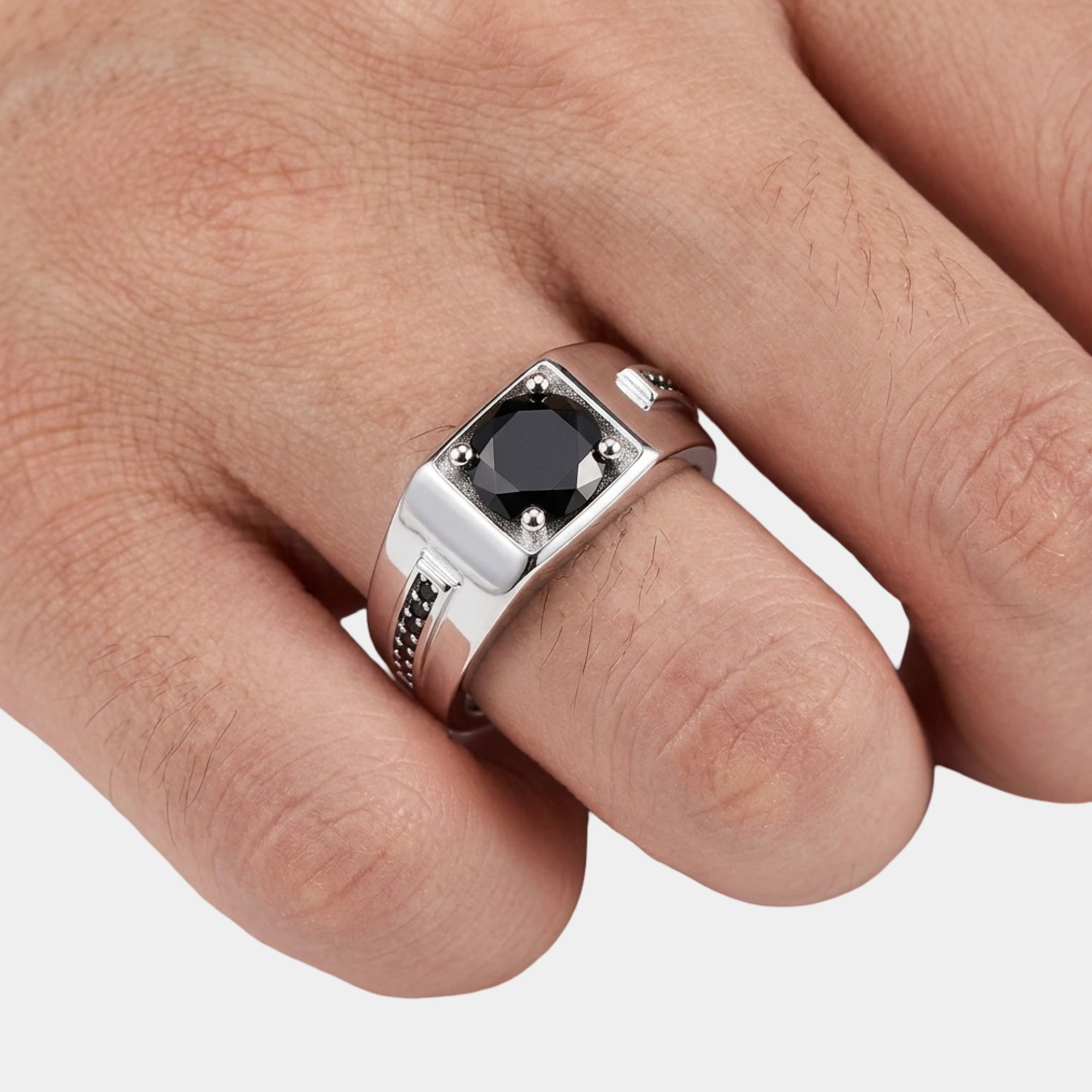 Close-up of the round black cubic zirconia on a men's silver band