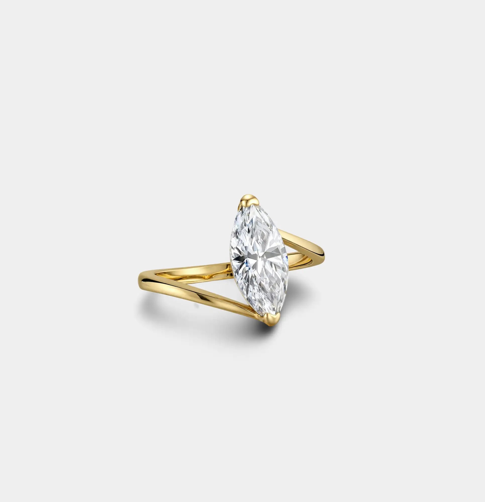 Angled view of a 2 carat marquise CZ ring in gold plated sterling silver with a split bypass band