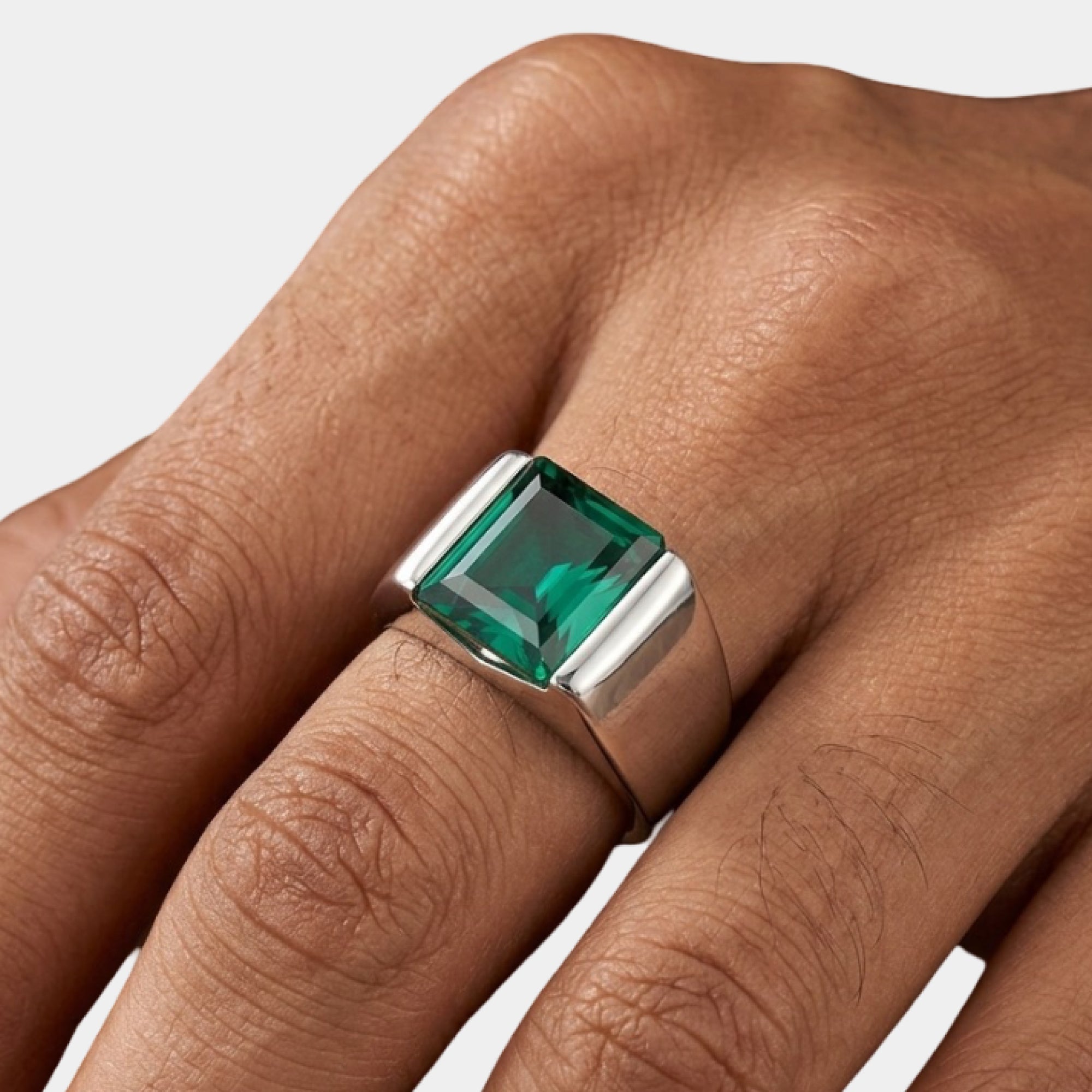 Close-up of the square green emerald on a silver men's ring