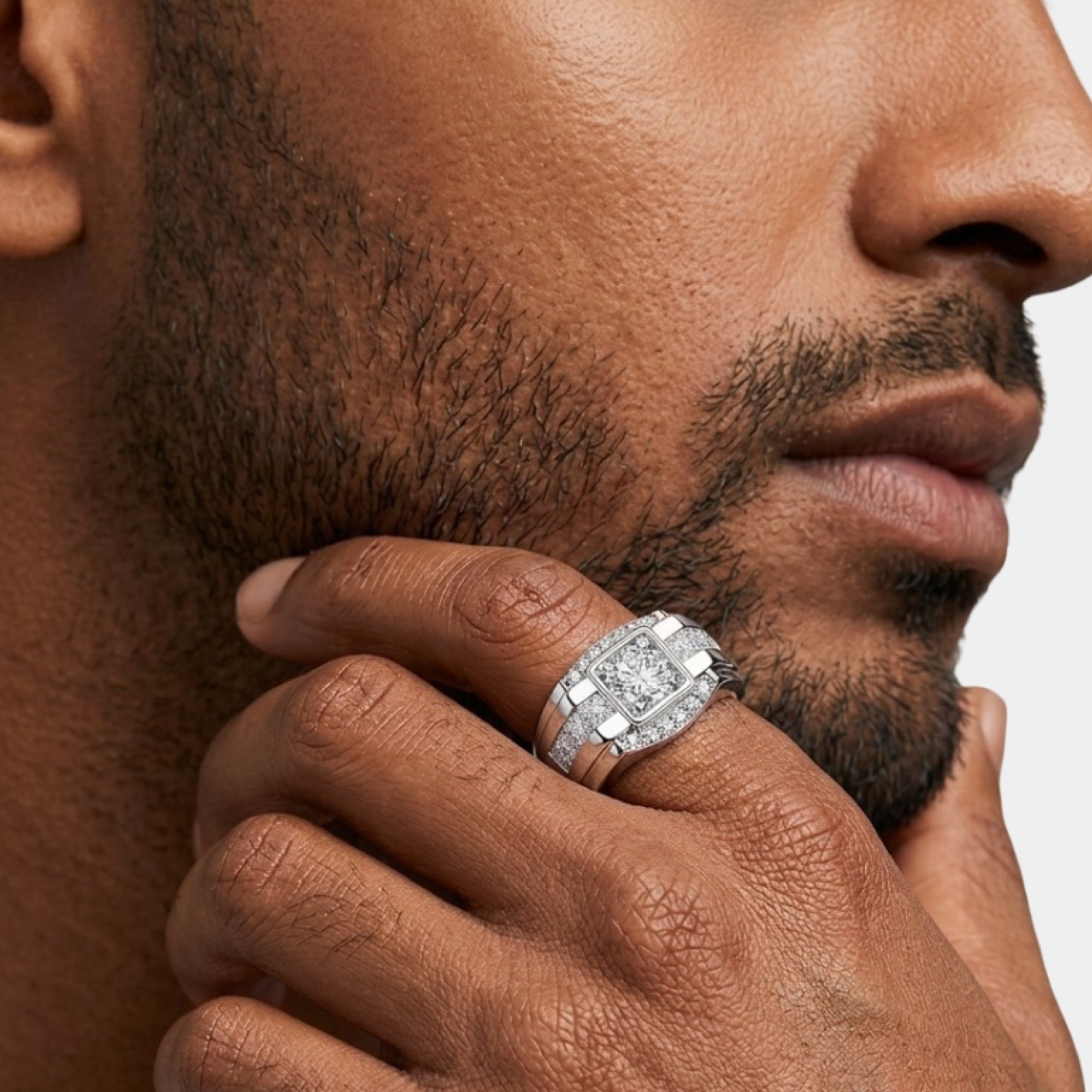 Close-up of the round moissanite center stone and halo on a men's silver ring