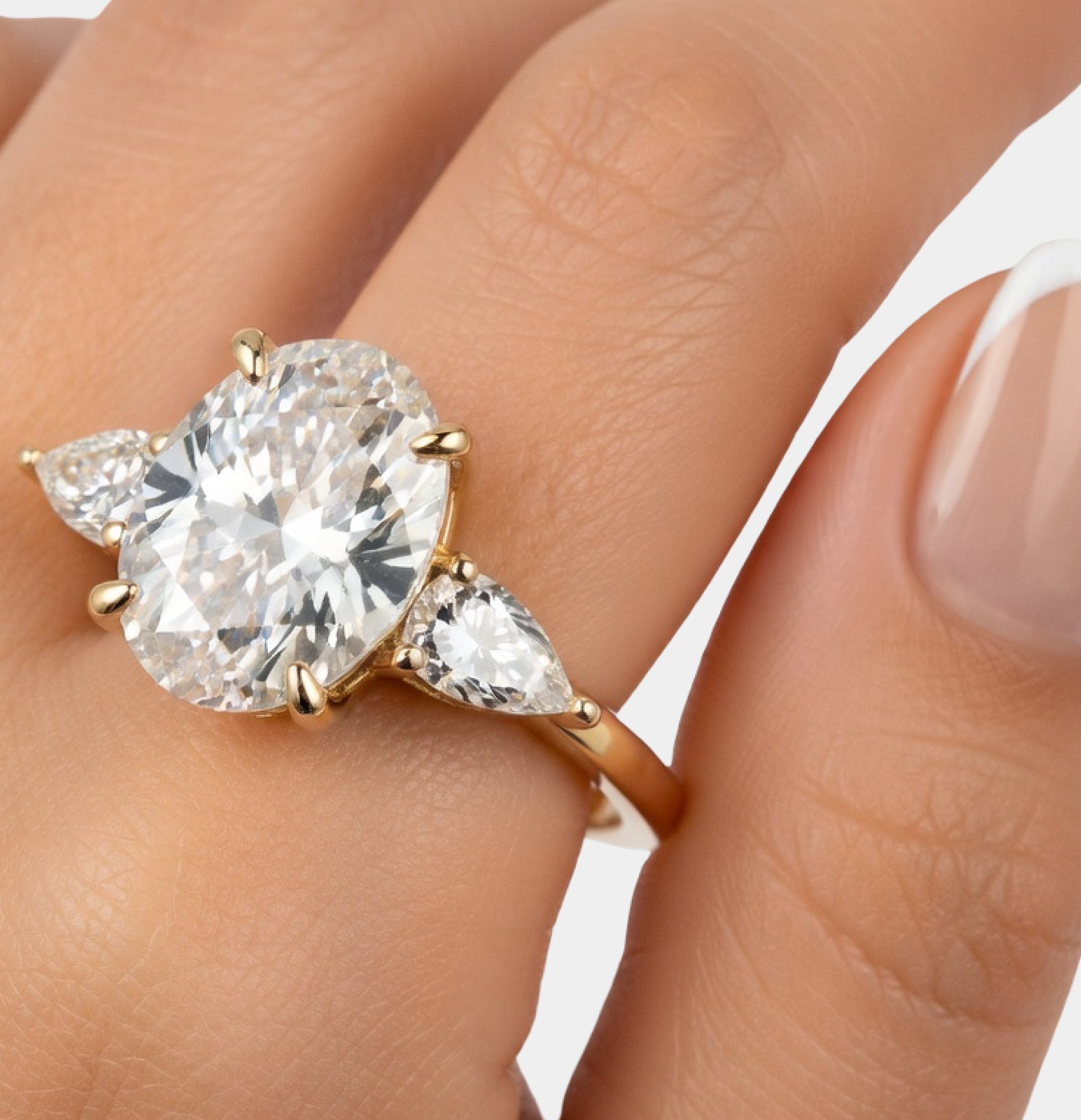 Close-up of the oval cubic zirconia center and pear side stones in a silver setting