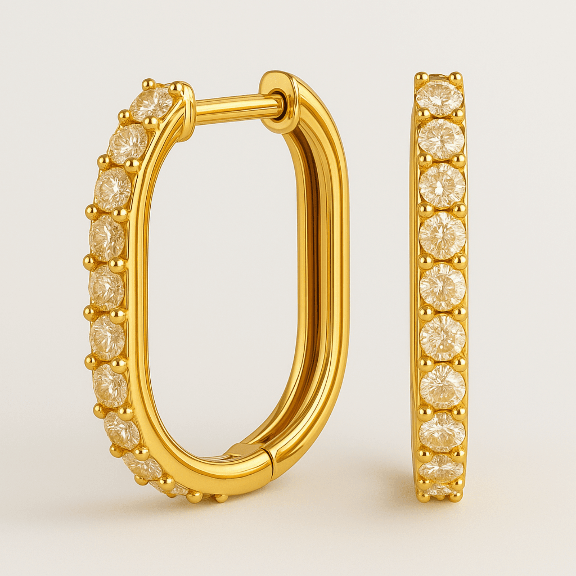 Pair of U-shaped gold huggie earrings in their gift-ready MH Elegance box