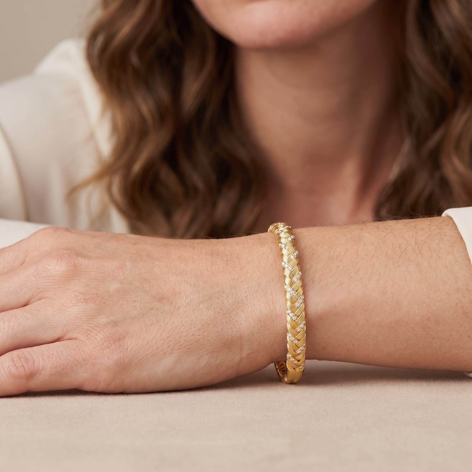 Close view of the Italian hand-carved braid and cubic zirconia rows on a wrist