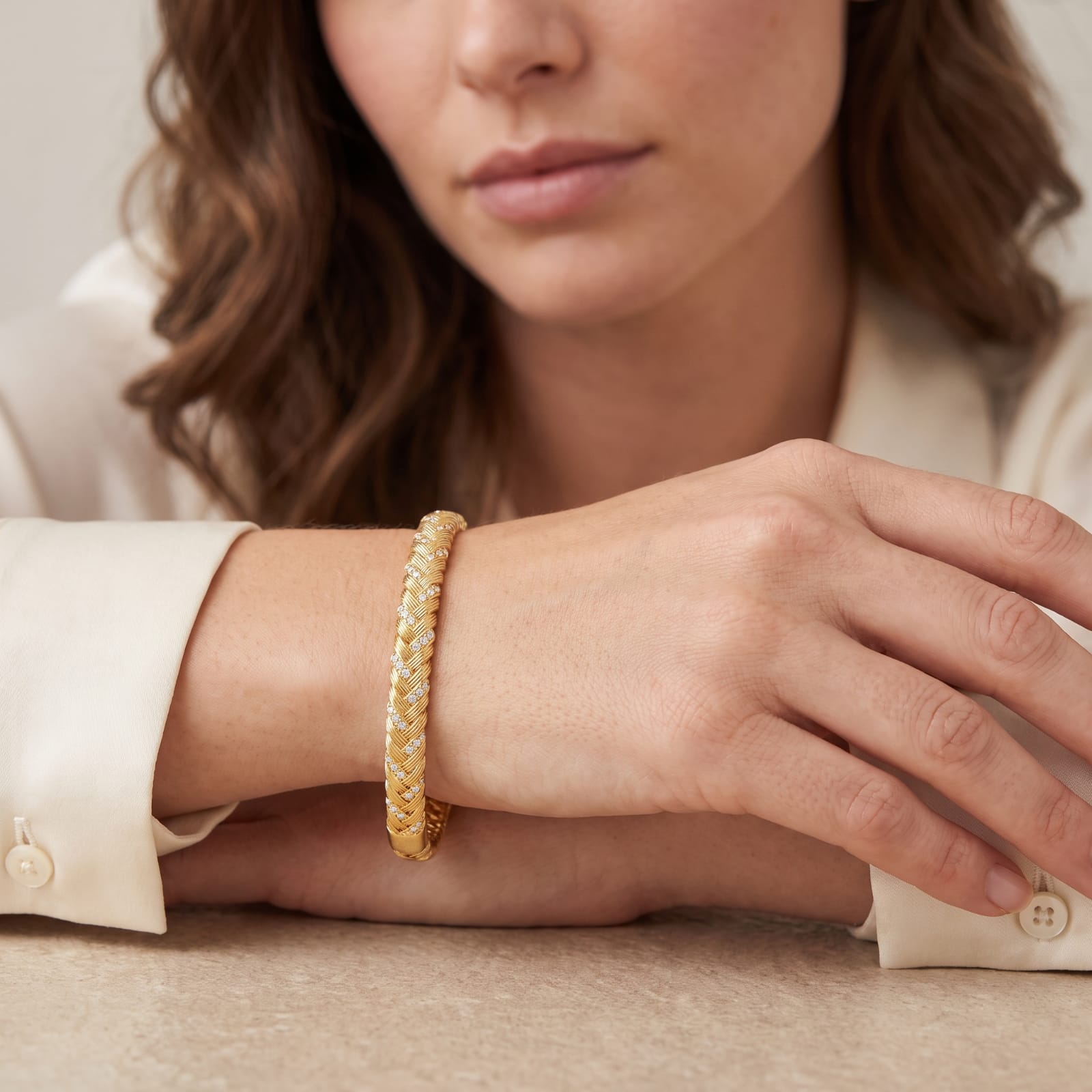 Braided gold cuff bangle with snap clasp styled for everyday wear