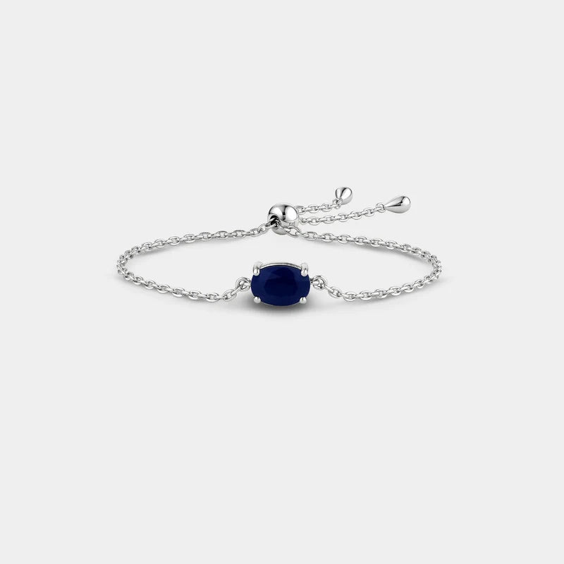 Silver bracelet with a blue gemstone on a white background